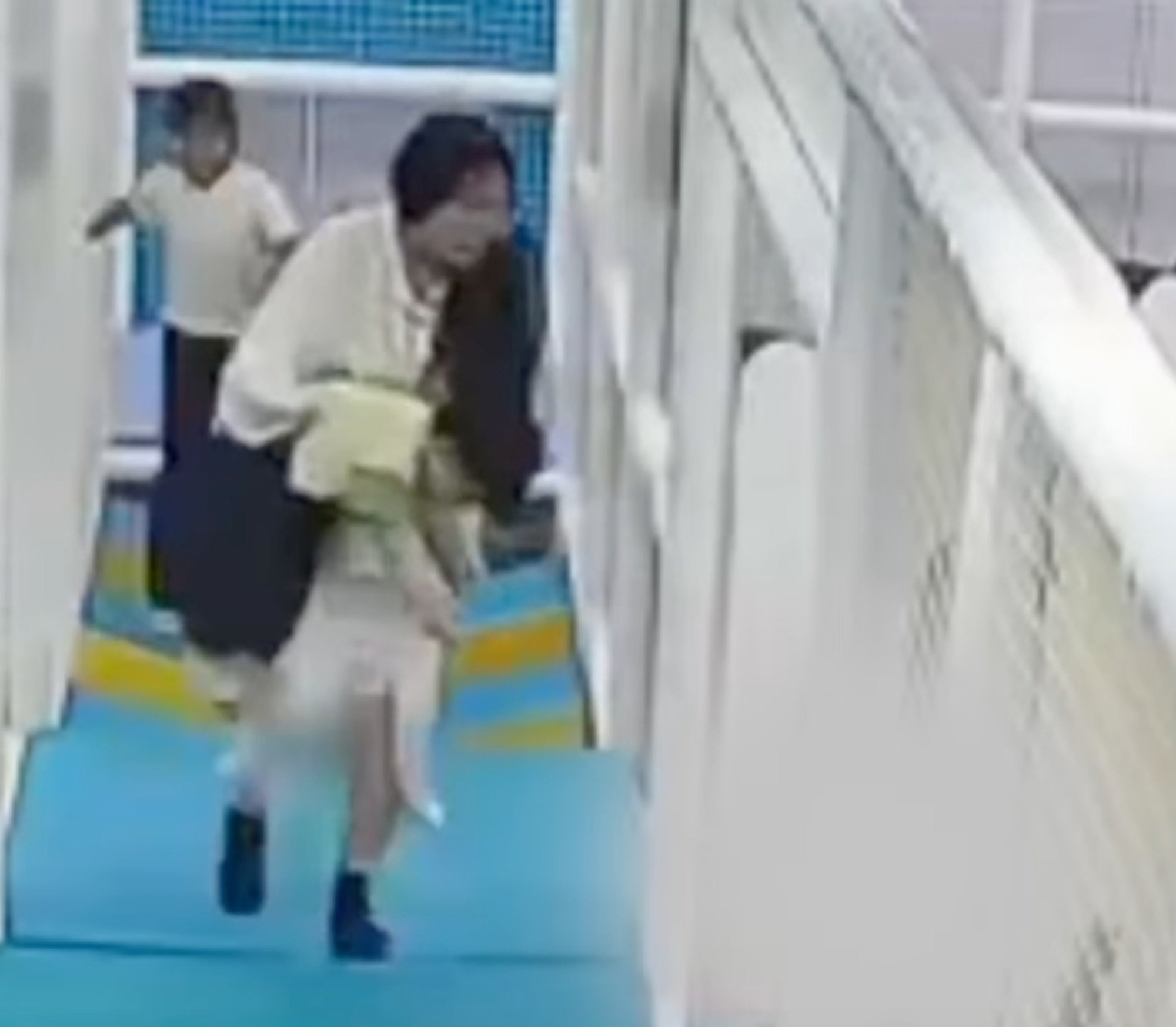 The youngster’s mother carries her son out of the playing area before trying to revive him. Photo: Weibo The youngster’s mother carries her son out of the playing area before trying to revive him. Photo: Weibo