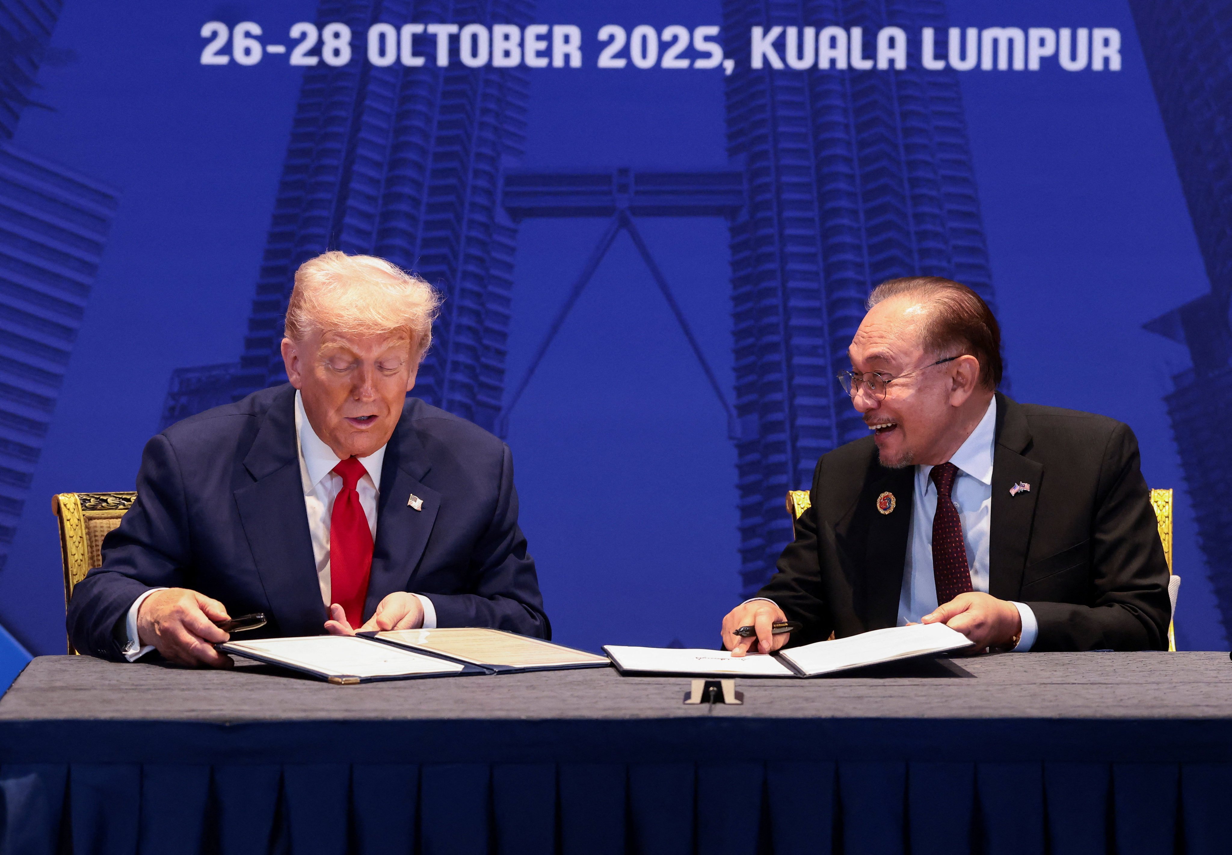 US President Donald Trump and Malaysian Prime Minister Anwar Ibrahim sign trade deal documents during a bilateral meeting at the Asean summit in Kuala Lumpur, Malaysia, on Sunday. Photo: Reuters