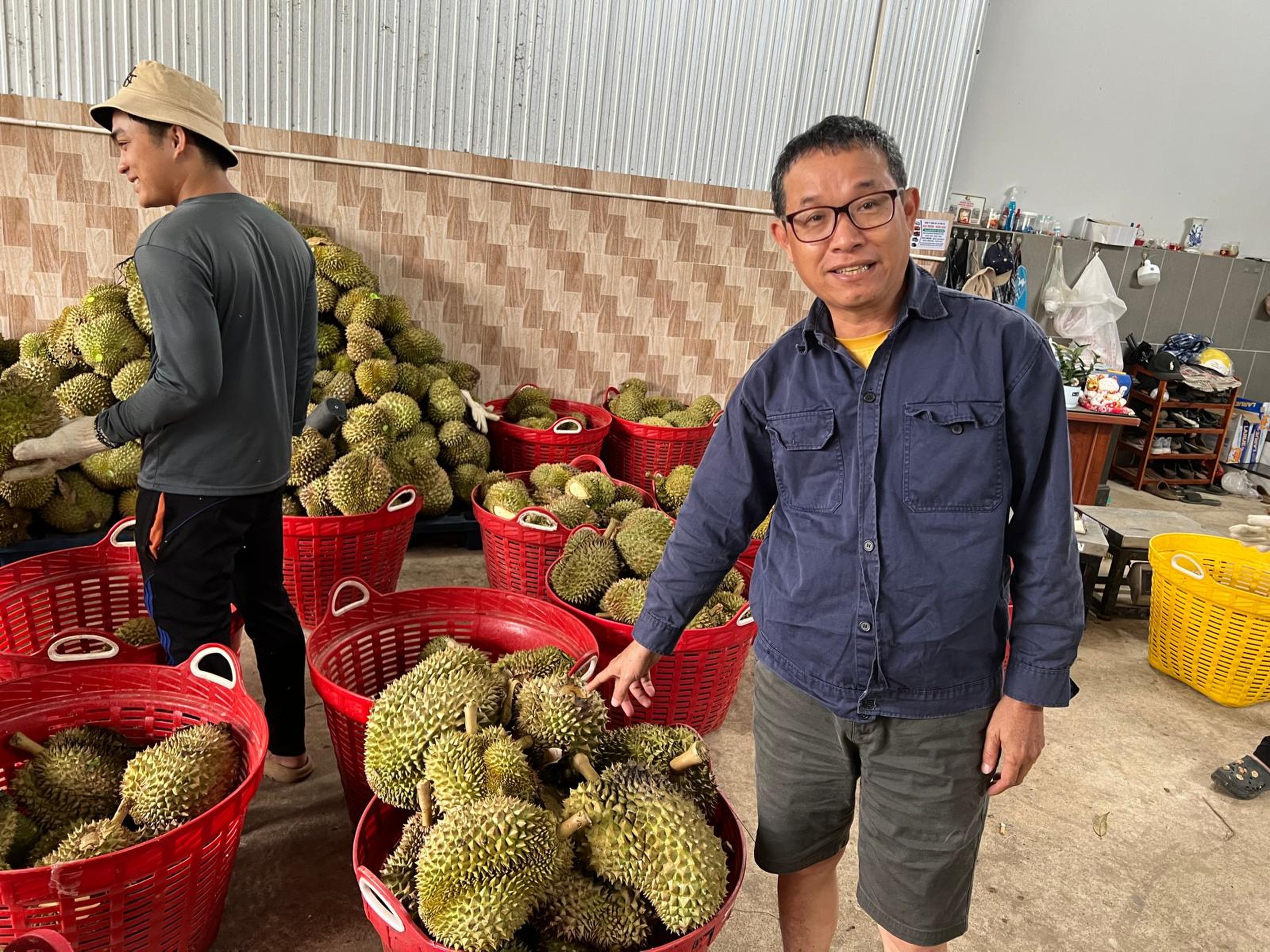 Vietnamese durian grower Huynh Kuan Thu with fruits from his plantation on October 11. Photo: Ralph Jennings