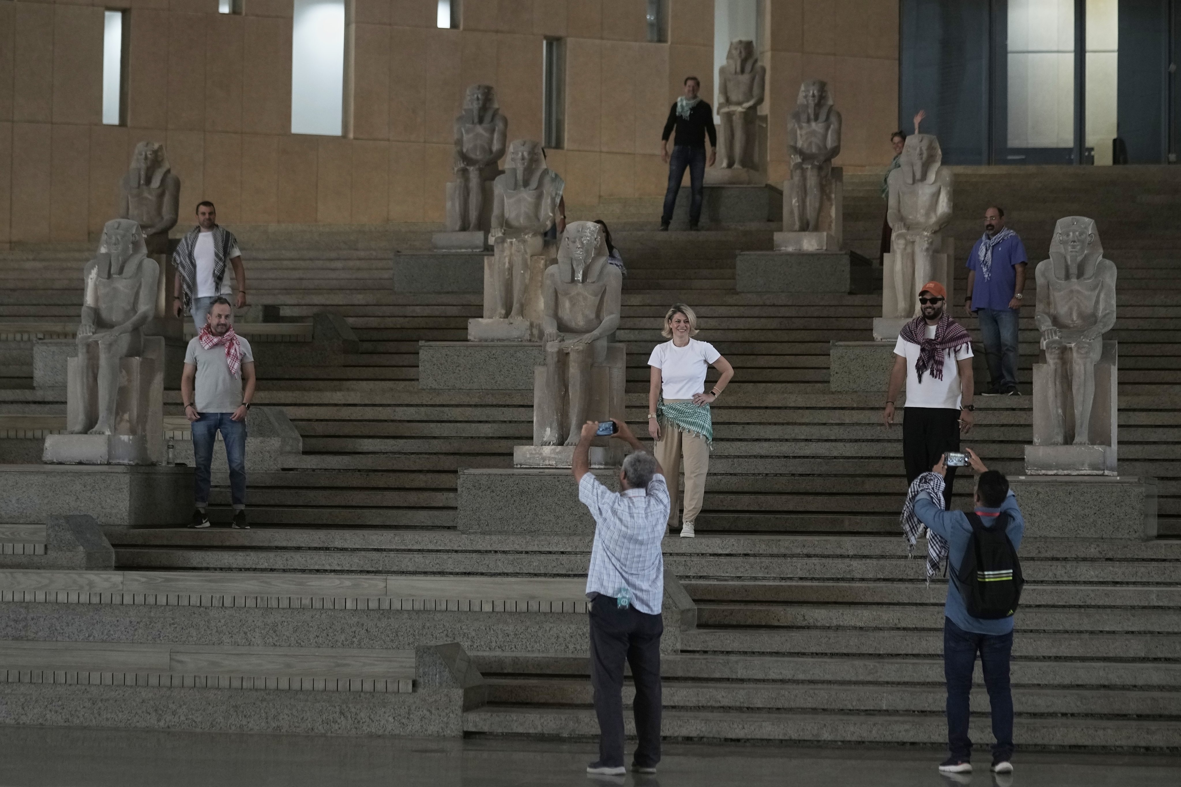 Tourists pose at the main staircase at the Grand Egyptian Museum. Photo: AP
