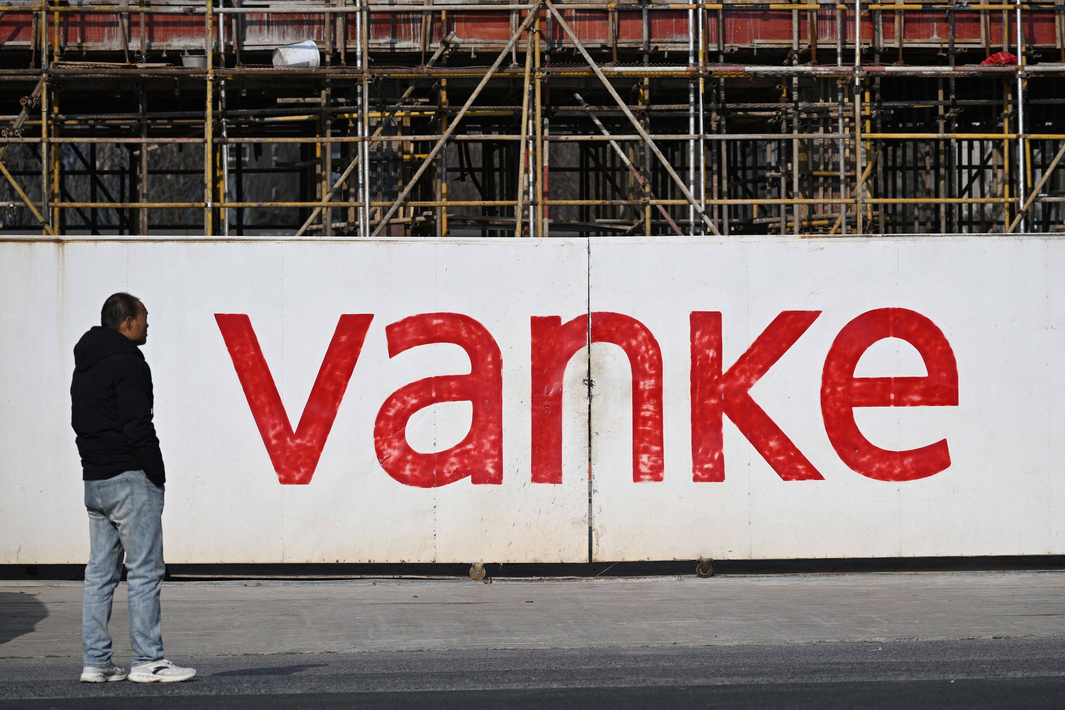 A man stands outside the construction site of a residential complex being built by Chinese real estate developer Vanke in Nanjing, in eastern China’s Jiangsu province, on February 13, 2025. Photo: AFP