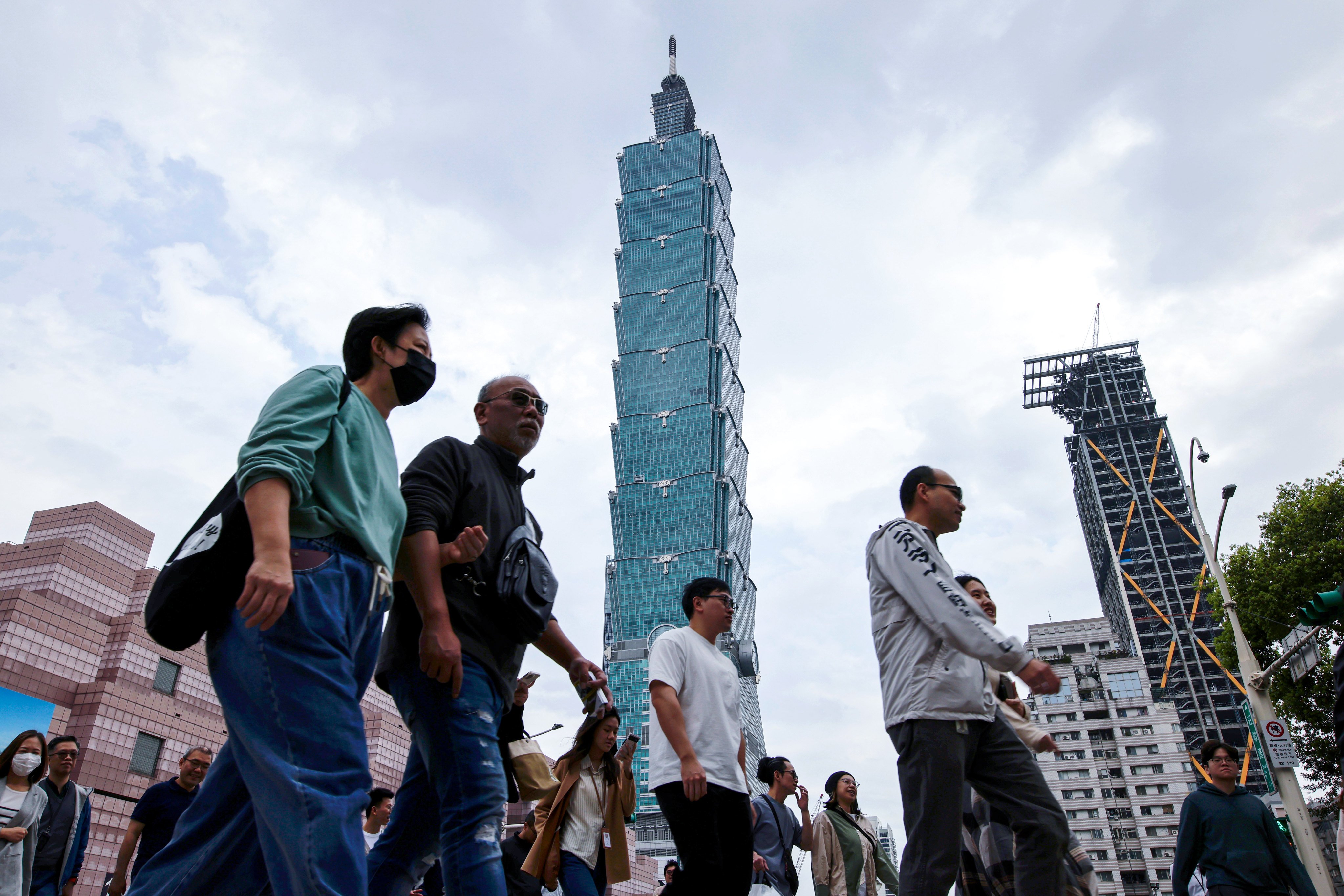 People walk past the Taipei 101 skyscraper in Taipei, Taiwan, on April 7. An official commentary published by Xinhua stated that after peaceful reunification, Taiwan’s current social system and way of life would be fully respected. Photo: EPA-EFE