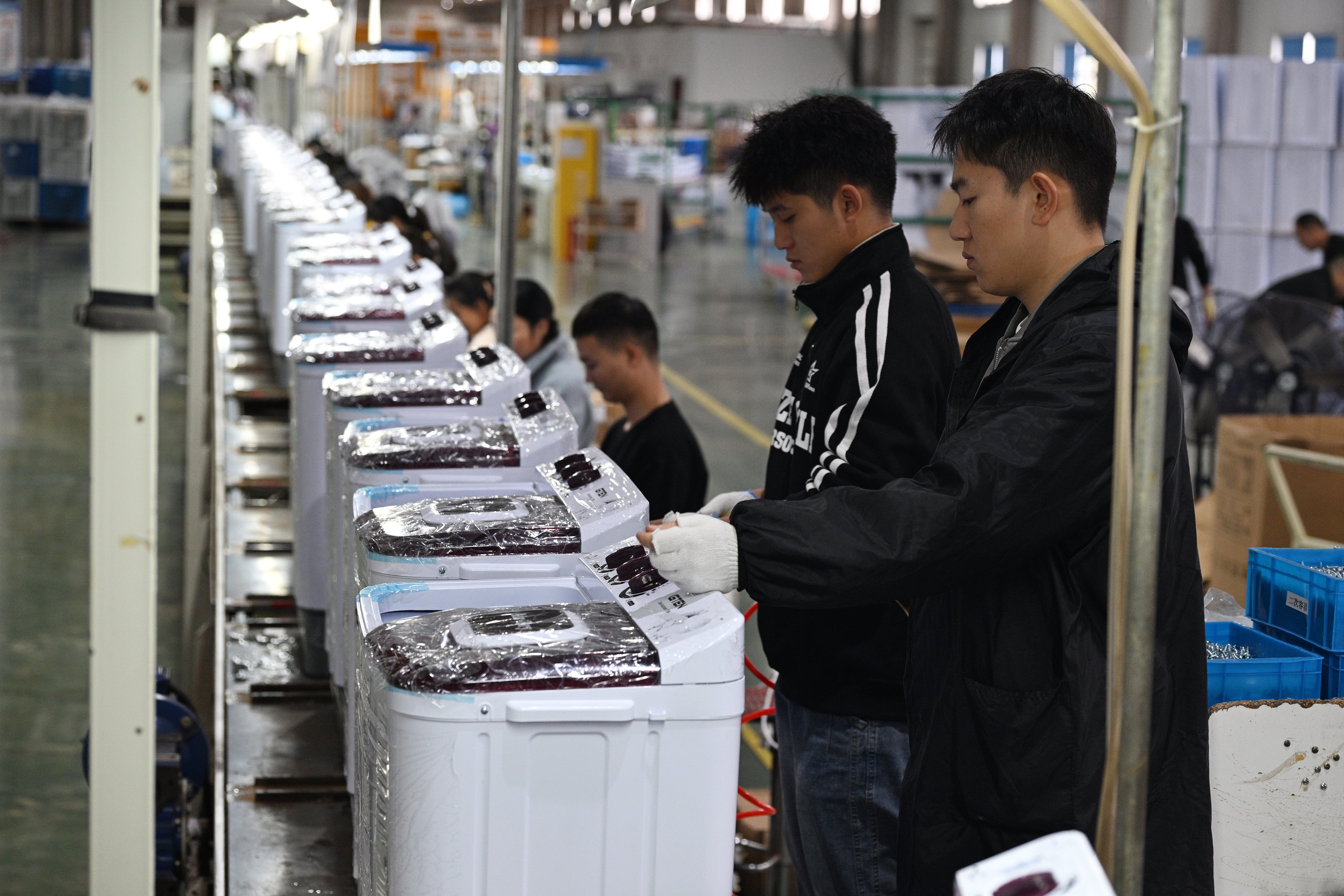 People work at a factory making washing machines for export in China’s eastern Jiangsu province. Photo: Getty Images