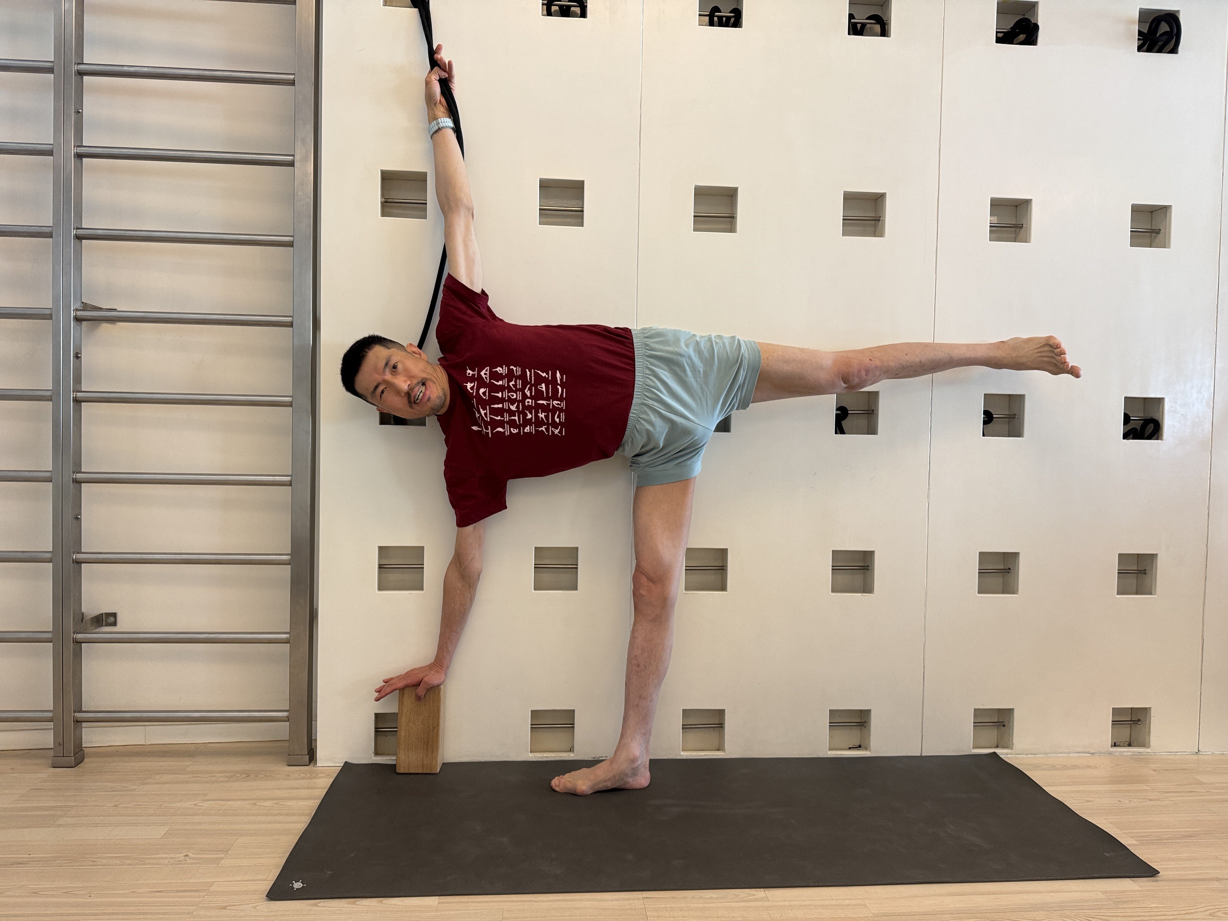 Hong Kong mutual fund executive David Lee uses props to do an Iyengar yoga pose. With regular practice aided by a teacher, yoga is helping slow down the progress of his neurodegenerative disease. Photo: IYCHK