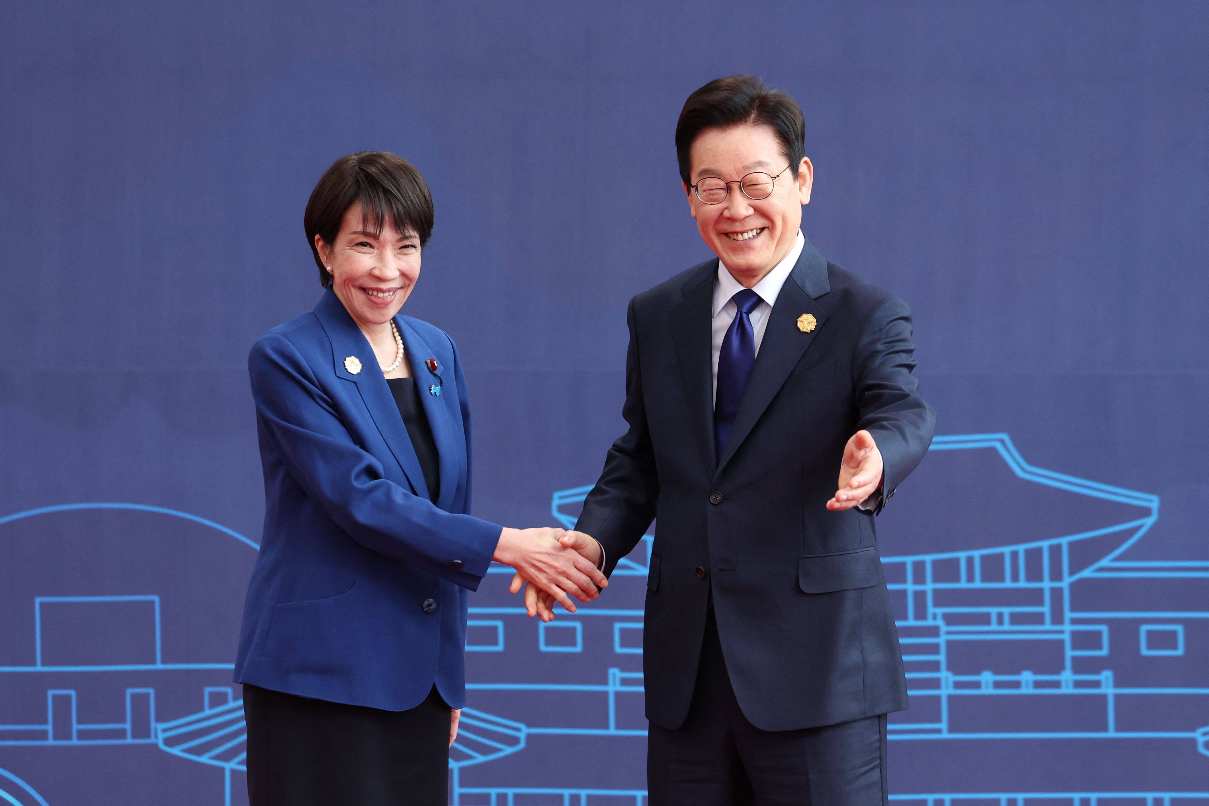 South Korea’s President Lee Jae-myung welcoming Japan’s Prime Minister Sanae Takaichi to the Apec summit in Gyeongju on Friday. Photo: AFP/Apec 2025 Korea via Yonhap/Handout