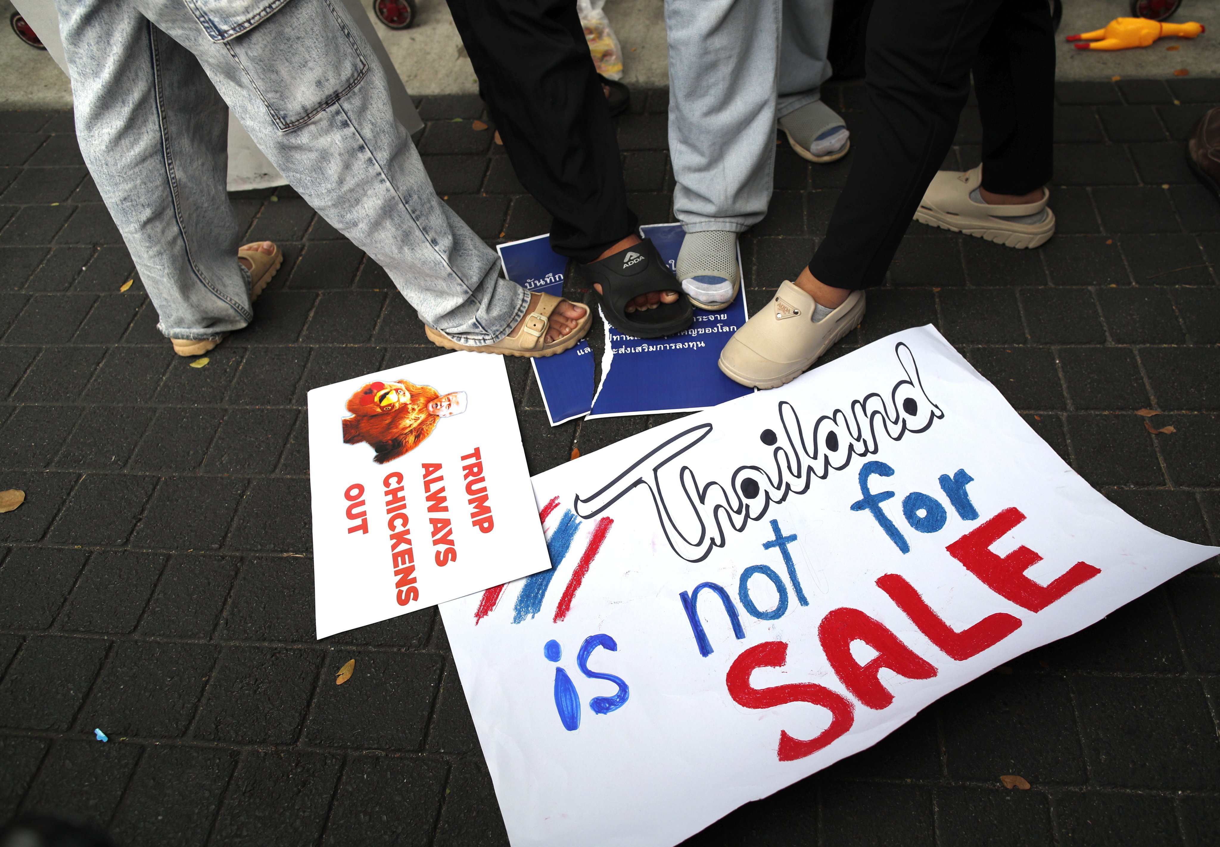 Thai demonstrators step on a mock memorandum of understanding during a protest outside the US embassy in Bangkok on Thursday against a Thai-US agreement on rare earth cooperation. Photo: EPA