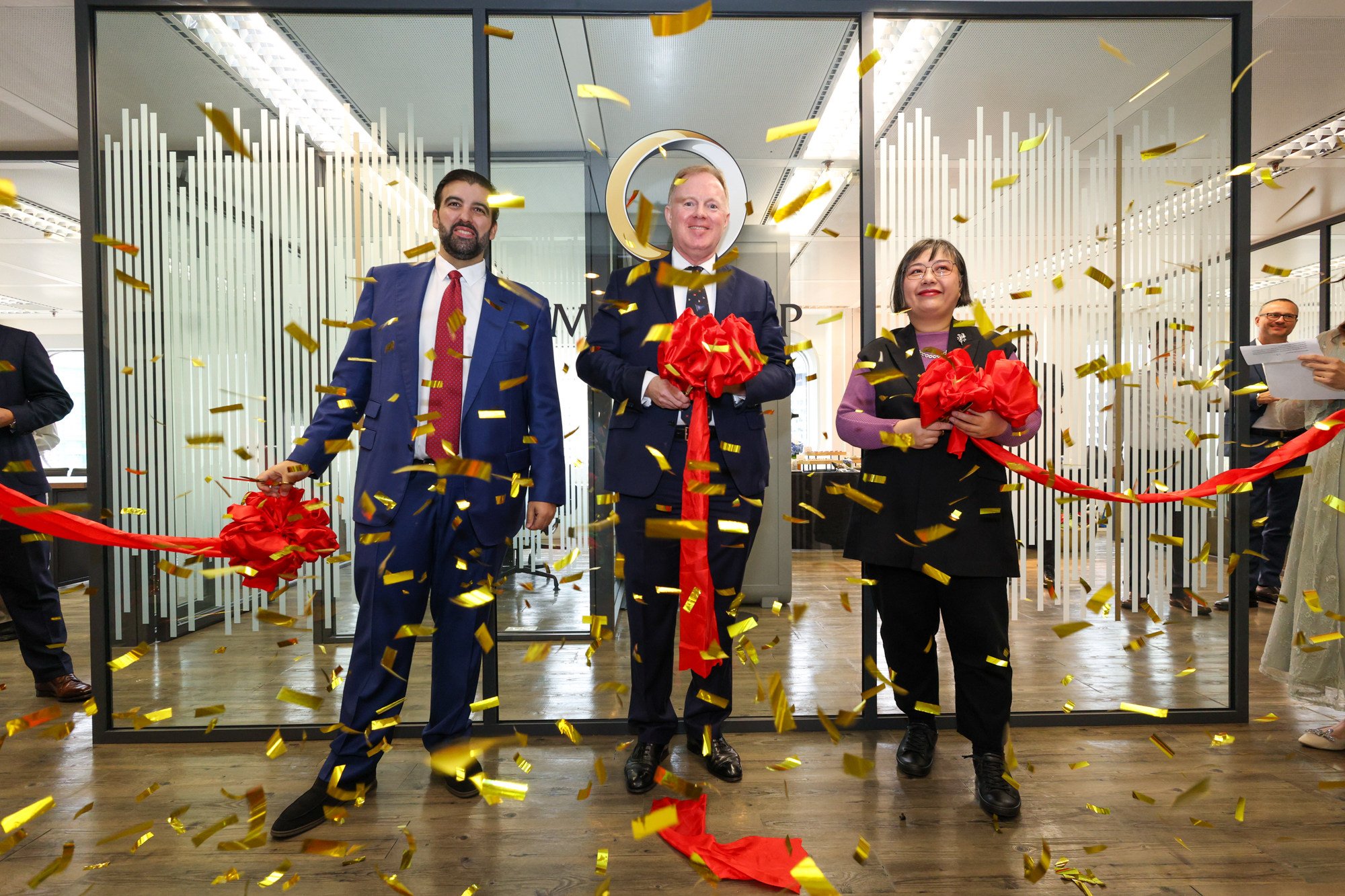 MKS PAMP CEO James Emmett, centre, leads the opening of the Swiss firm’s regional headquarters in Hong Kong on Thursday, flanked by chief commercial officer Omar Liess and Angelica Leung, InvestHK’s head of consumer products. Photo: Handout