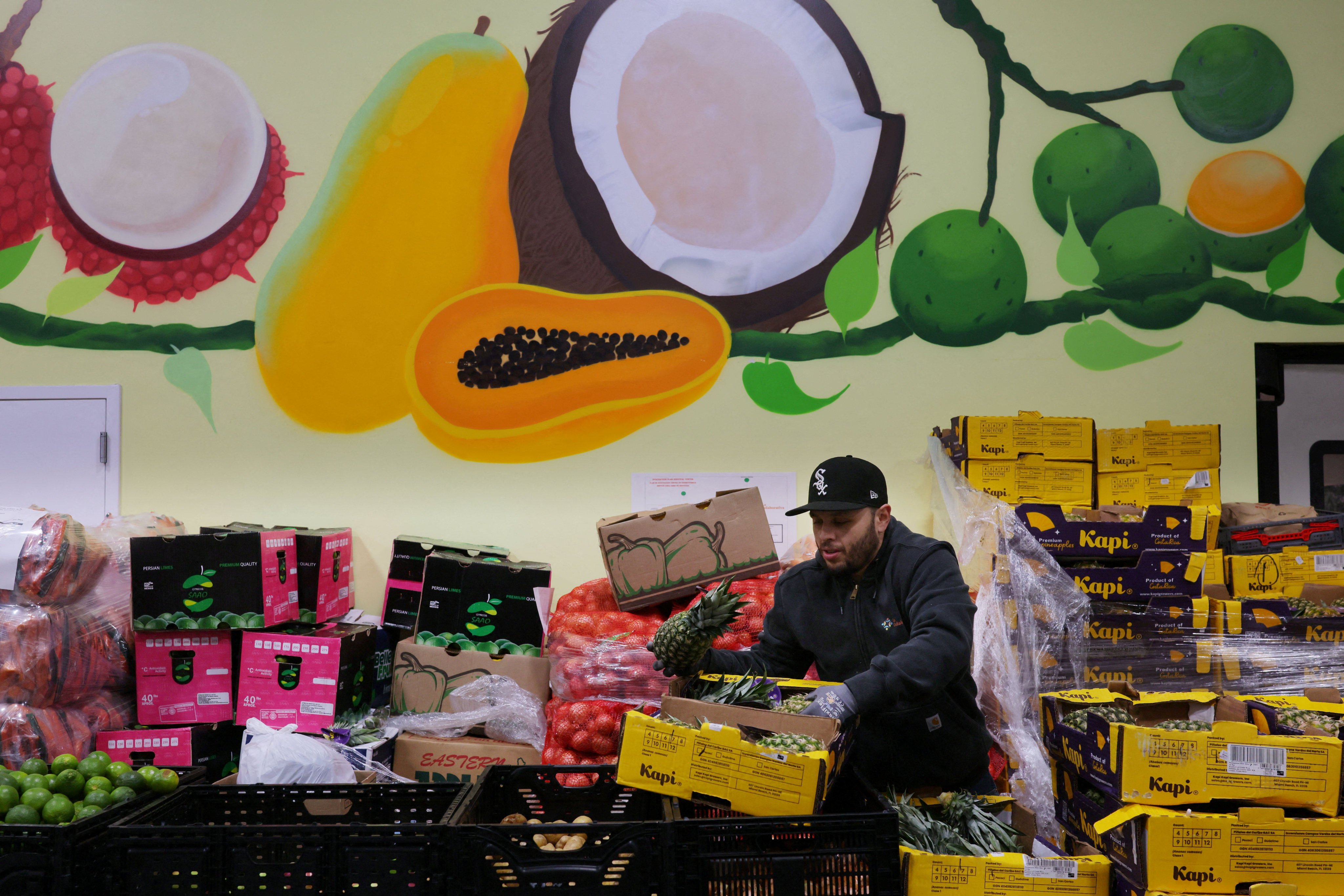 A worker sorts fresh fruit and vegetables at La Colaborativa’s food pantry in Chelsea, Massachusetts, on Wednesday. Photo: Reuters