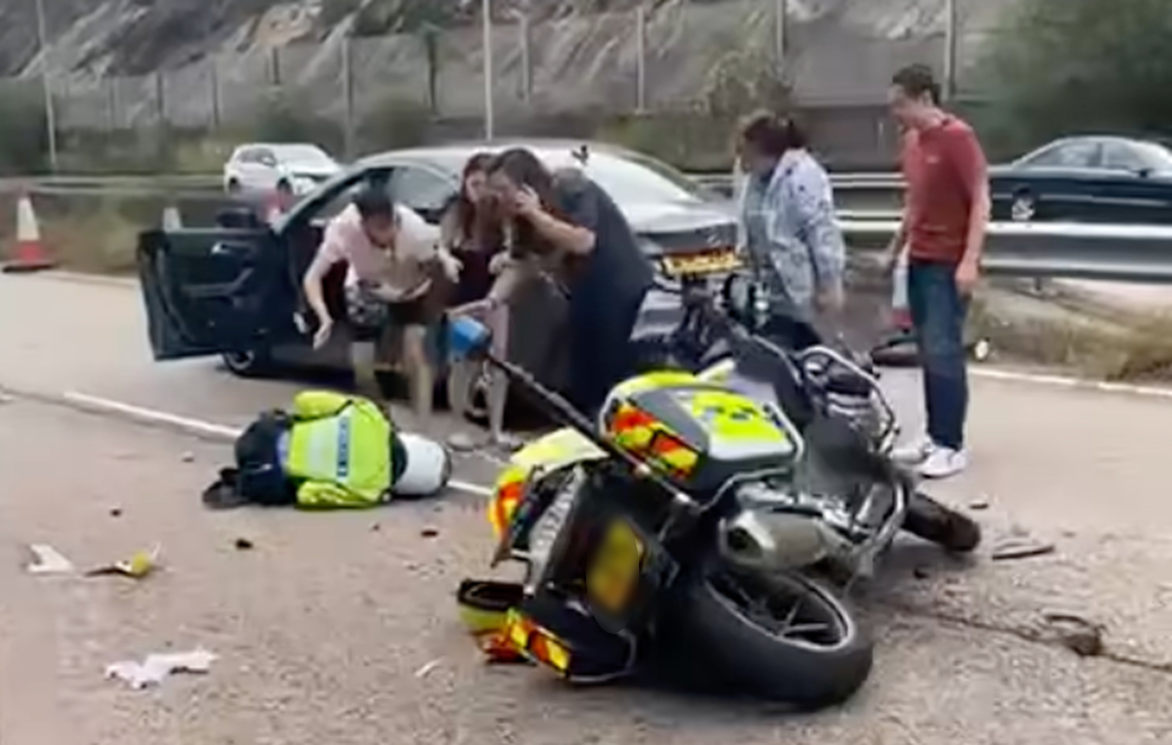 A Hong Kong police motorcycle has collided with a Mercedes-Benz limousine on a highway leading to Tai Lam Tunnel, injuring an officer and two others. Photo: Handout