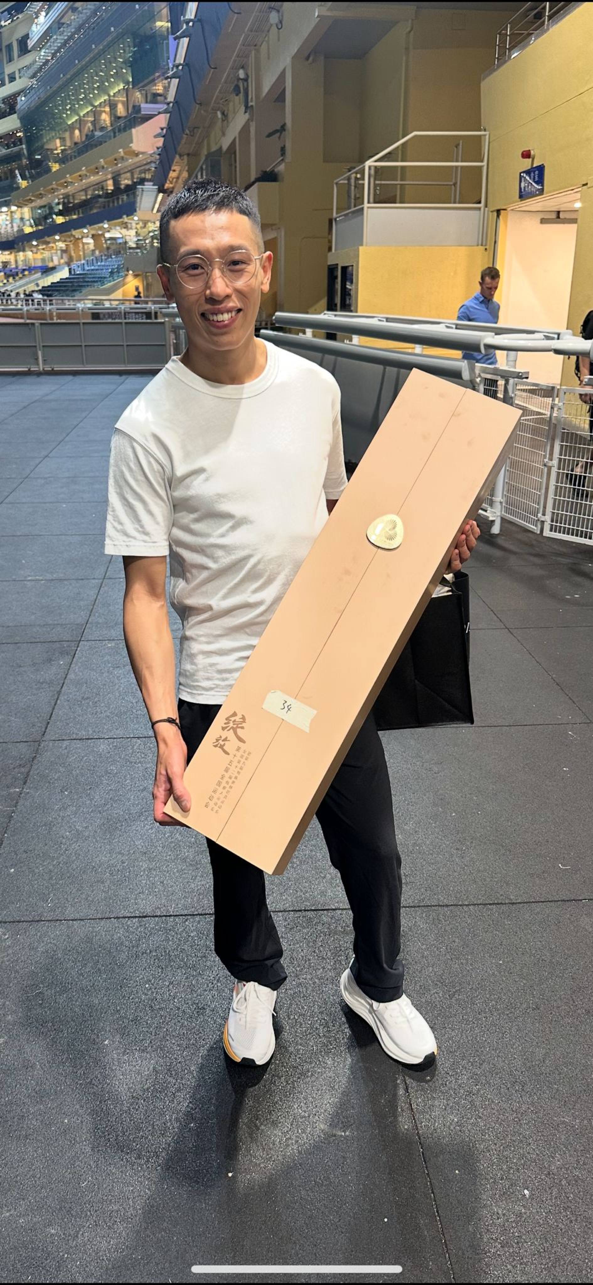 Vincent Ho leaves Happy Valley with his National Games torch. Photo: SCMP