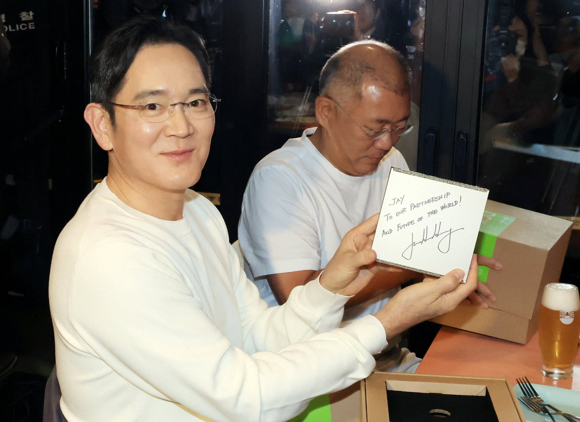 Samsung Electronics Chairman Jay Y. Lee (left) posed for photographs with a gift given by Nvidia CEO Jensen Huang during a dinner meeting with him and Hyundai Motor Group Executive Chair Chung Euisun (right) at a fried chicken restaurant in Seoul on October 30, 2025. Photo: Yonhap