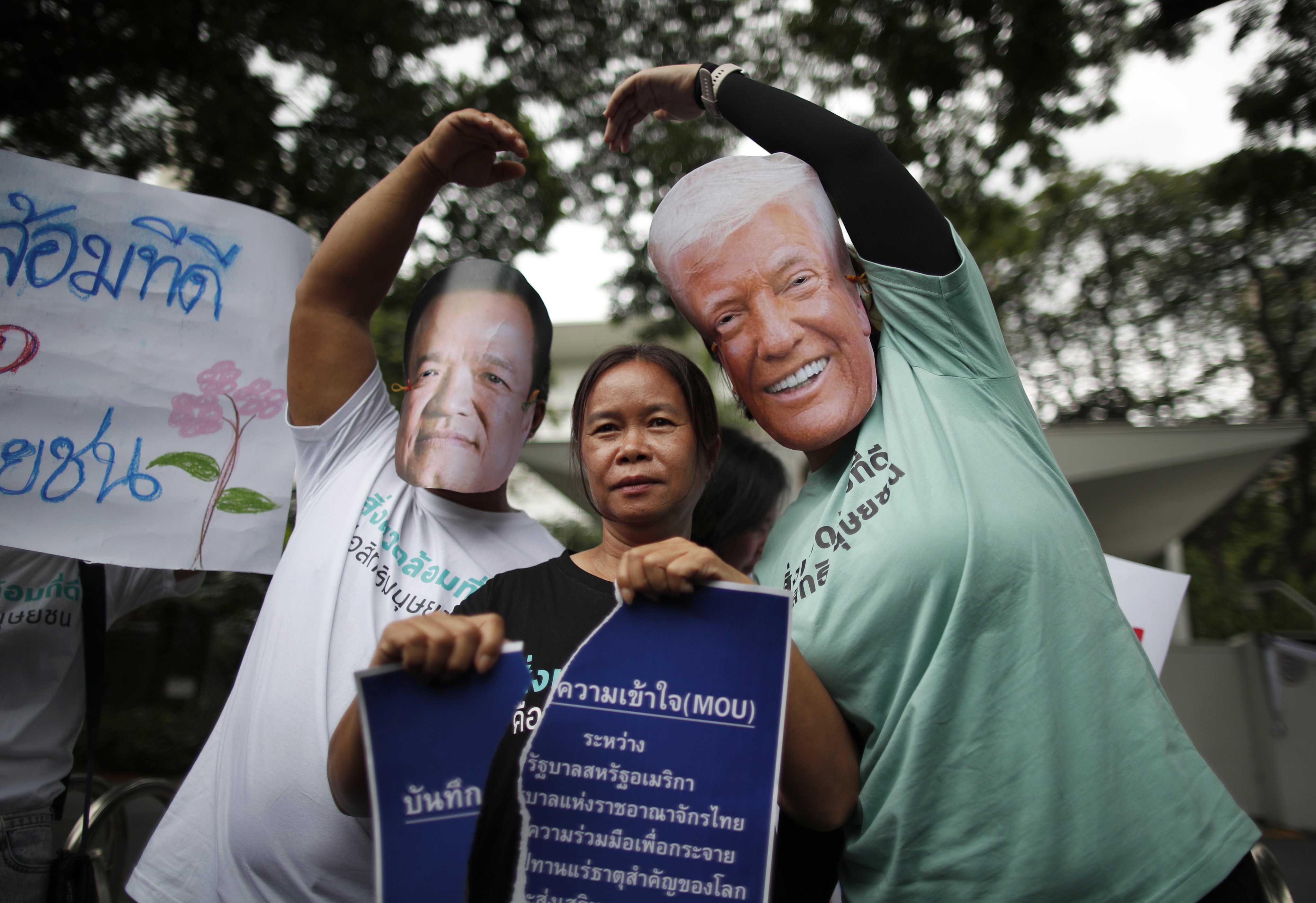 Thai demonstrators wearing masks of Thai Prime Minister Anutin Charnvirakul and US President Donald Trump protest against 
a US-Thailand memorandum of understanding on rare earth minerals cooperation, outside the US Embassy in Bangkok, on October 30. Photo: EPA