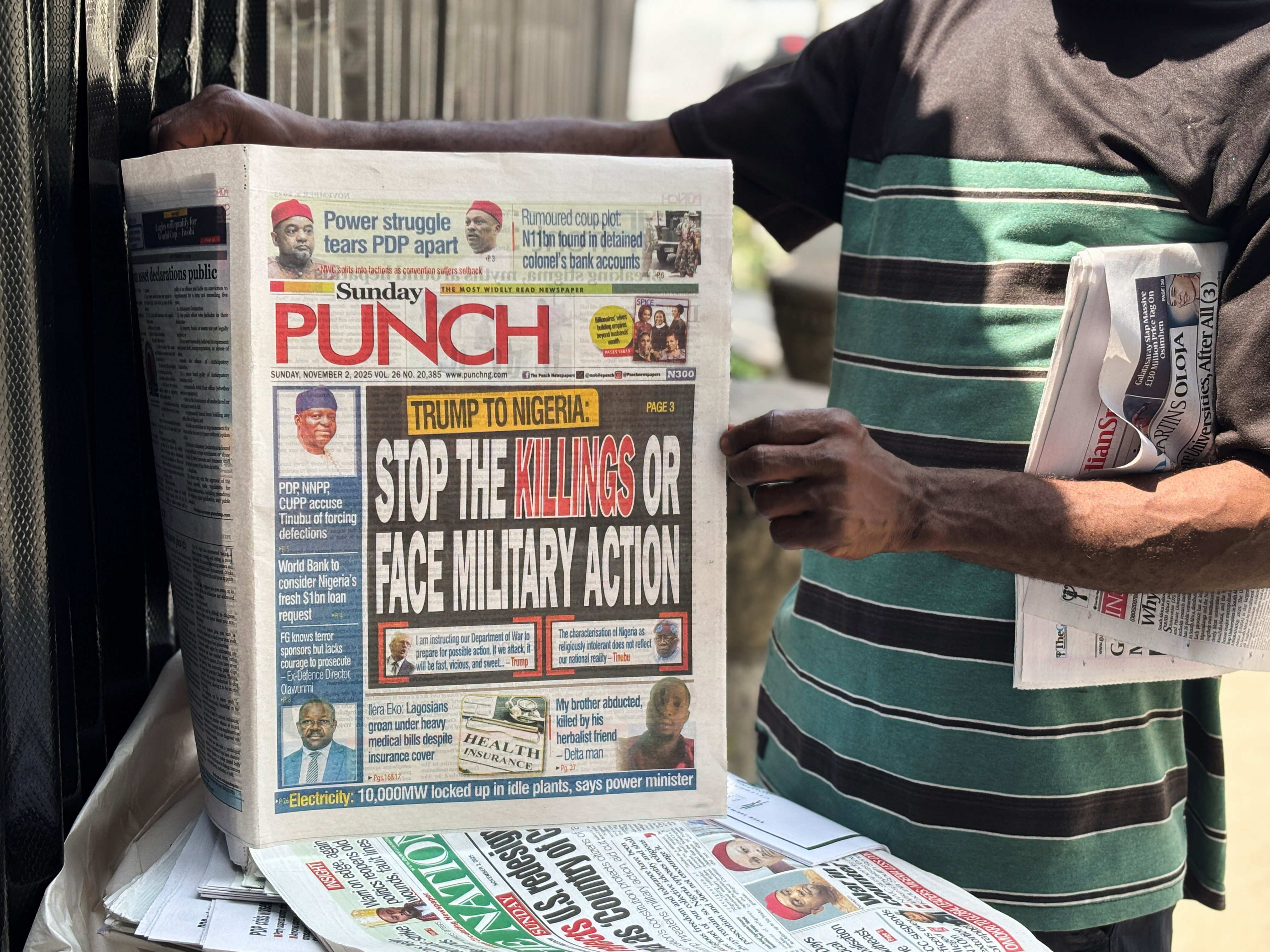 A vendor sells local newspapers with headlines referring to US President Donald Trump’s comments about Nigeria, on the street of Lagos, Nigeria, on Sunday. Photo: AP