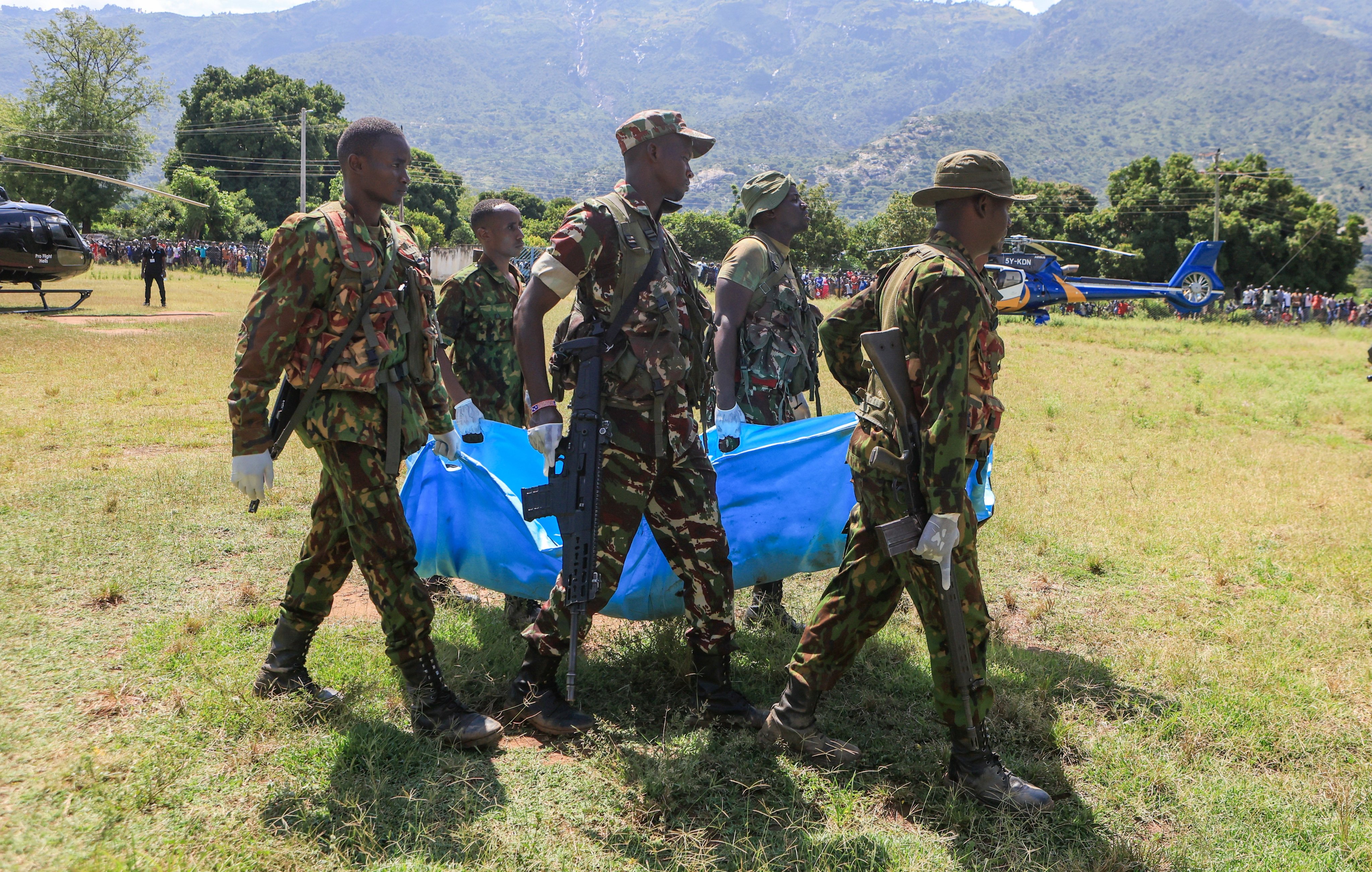 Rescue teams carry bodies of victims of a landslide in the hilly area of Chesongoch in Elgeyo Marakwet county, western Kenya on Sunday. Photo: AP
