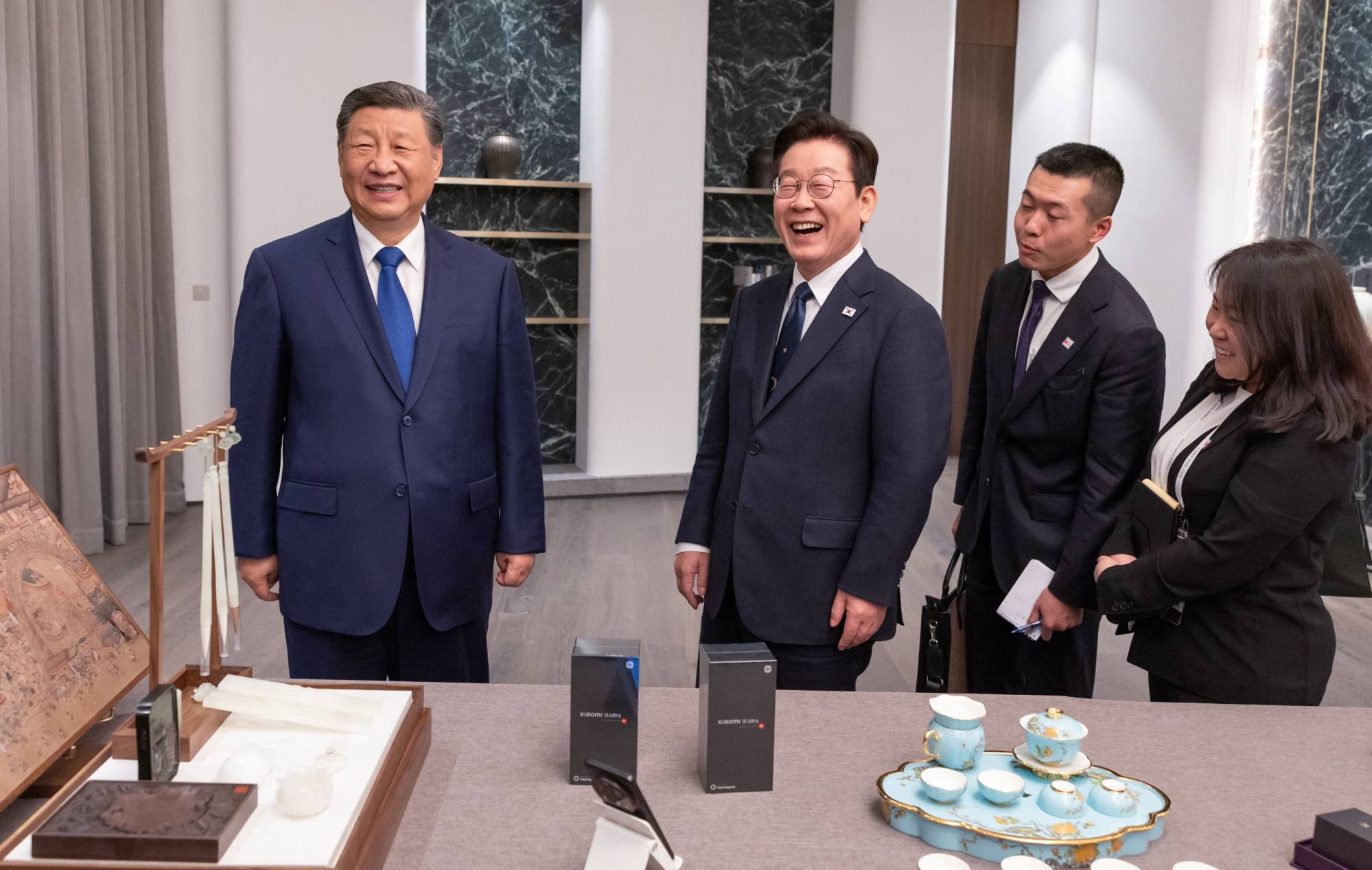 Chinese President Xi Jinping and his South Korean counterpart, Lee Jae-myung, share a laugh when they exchanged gifts at their meeting on Saturday in the Korean coastal city of Gyeongju. Photo: AFP