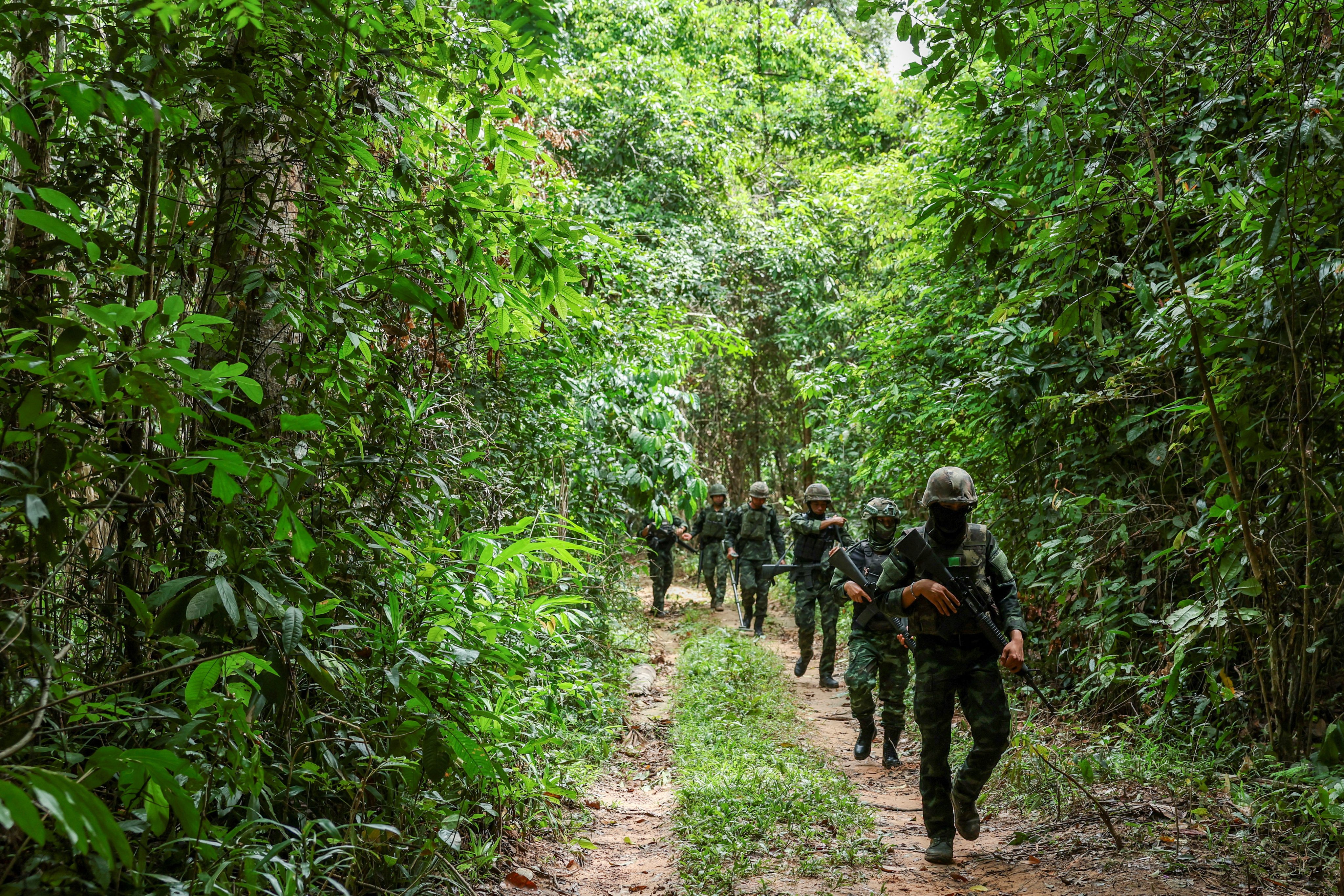 Thai military personnel walk near the forested disputed border between Thailand and Cambodia in the Chong Bok area in August. Photo: Reuters