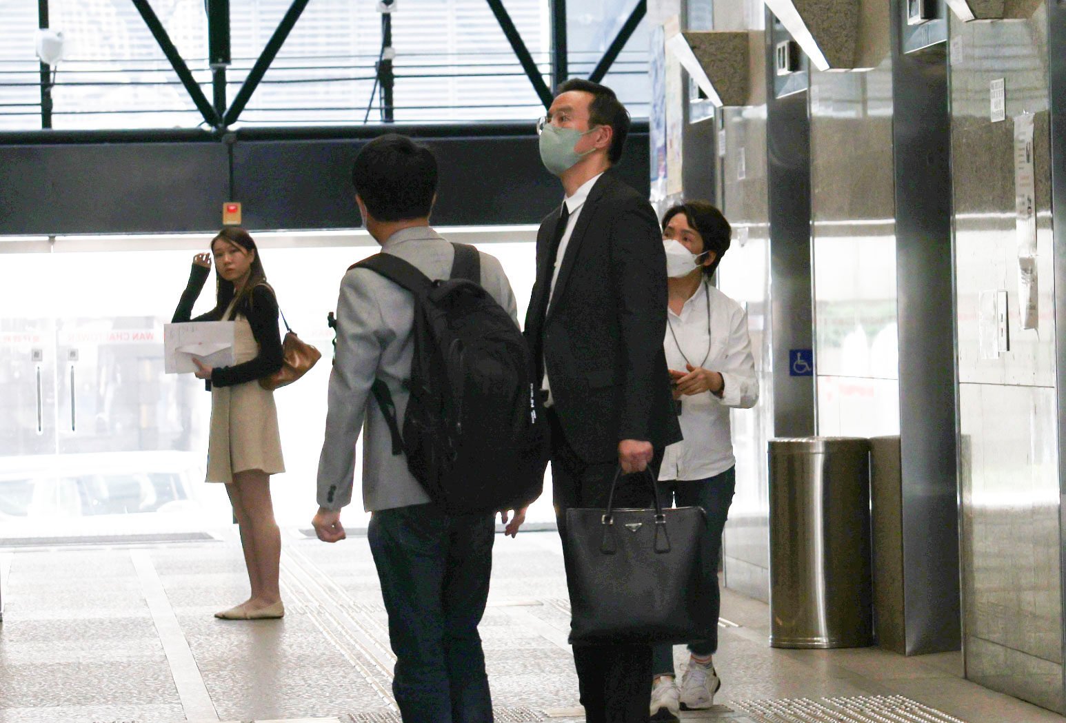 Henry Kwok (second from right) arrives at the District Court for an earlier hearing. Photo: Brian Wong
