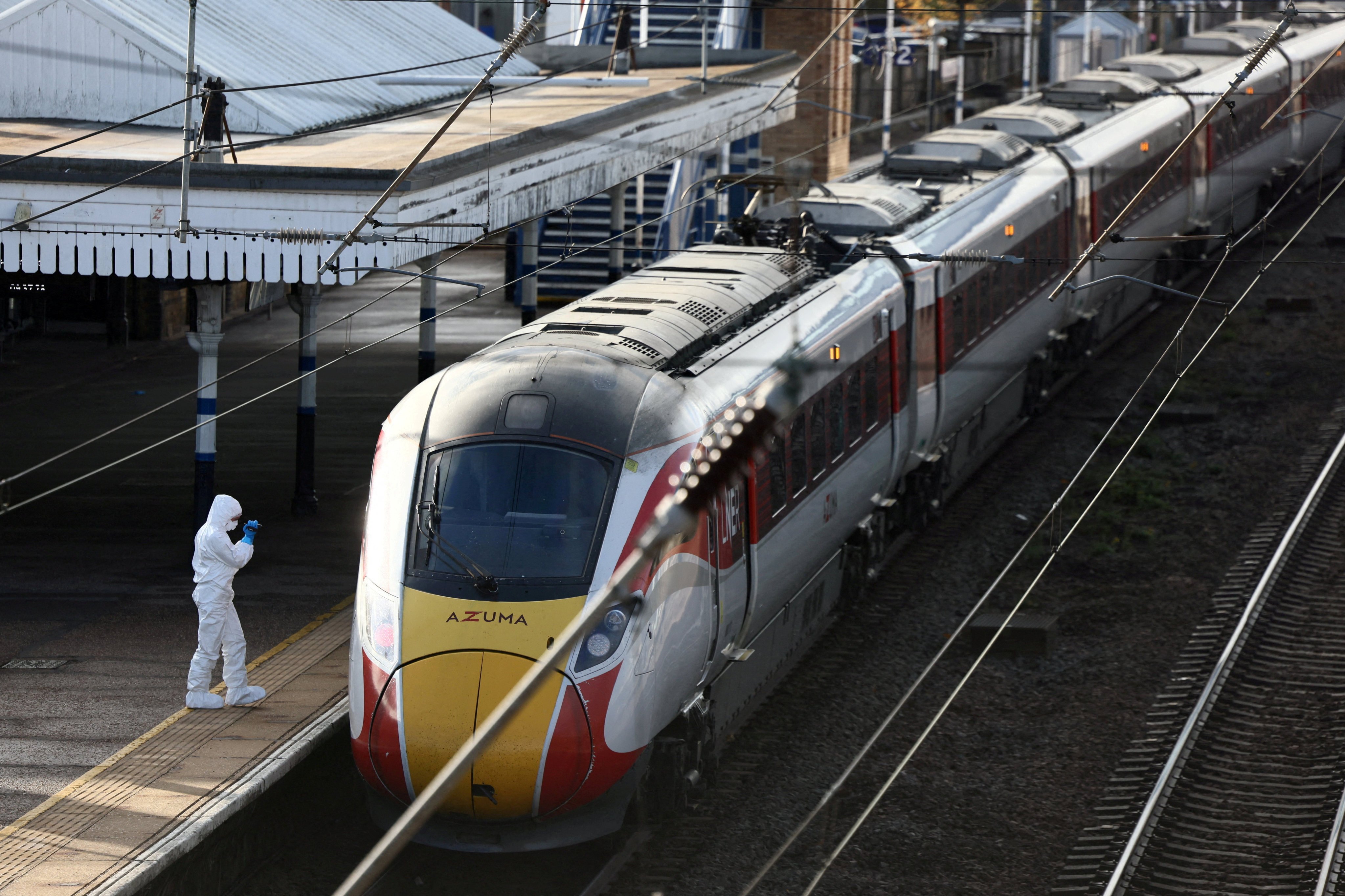 A forensic officer inspects the London North Eastern Railway (LNER) train on a platform at Huntingdon Station, near Cambridge, Britain. Photo: Reuters