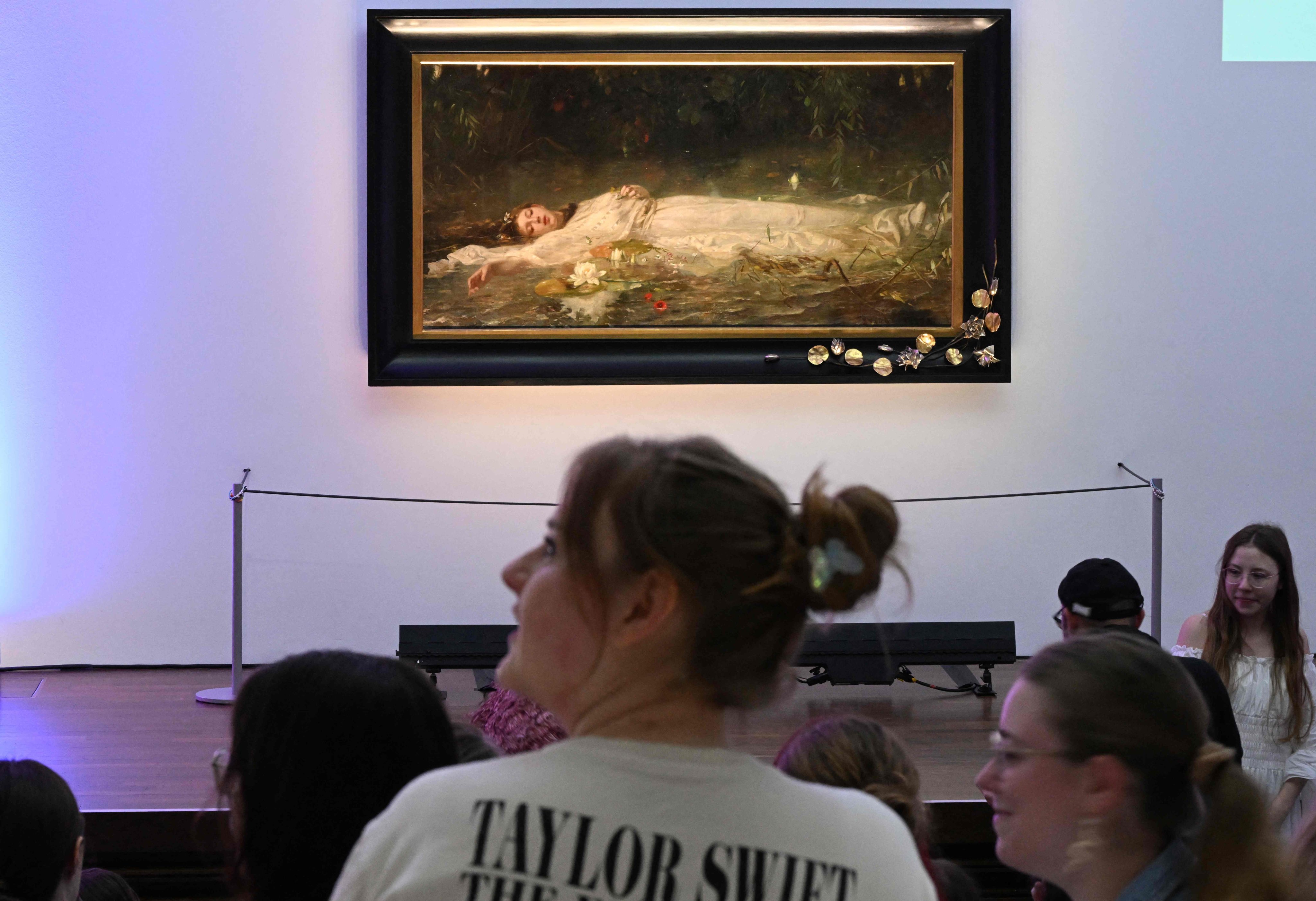 Taylor Swift fans listen to a lecture about the painting “Ophelia” by German artist Friedrich Heyser during a tour at Museum Wiesbaden in western Germany on Sunday. Photo: AFP