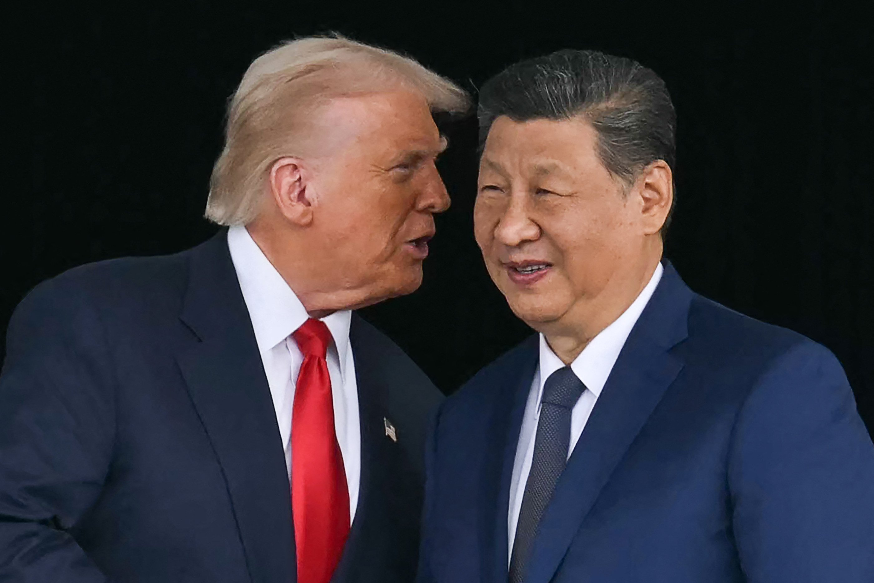 US President Donald Trump (left) talks to Chinese President Xi Jinping after their meeting in South Korea on Thursday. Photo: TNS