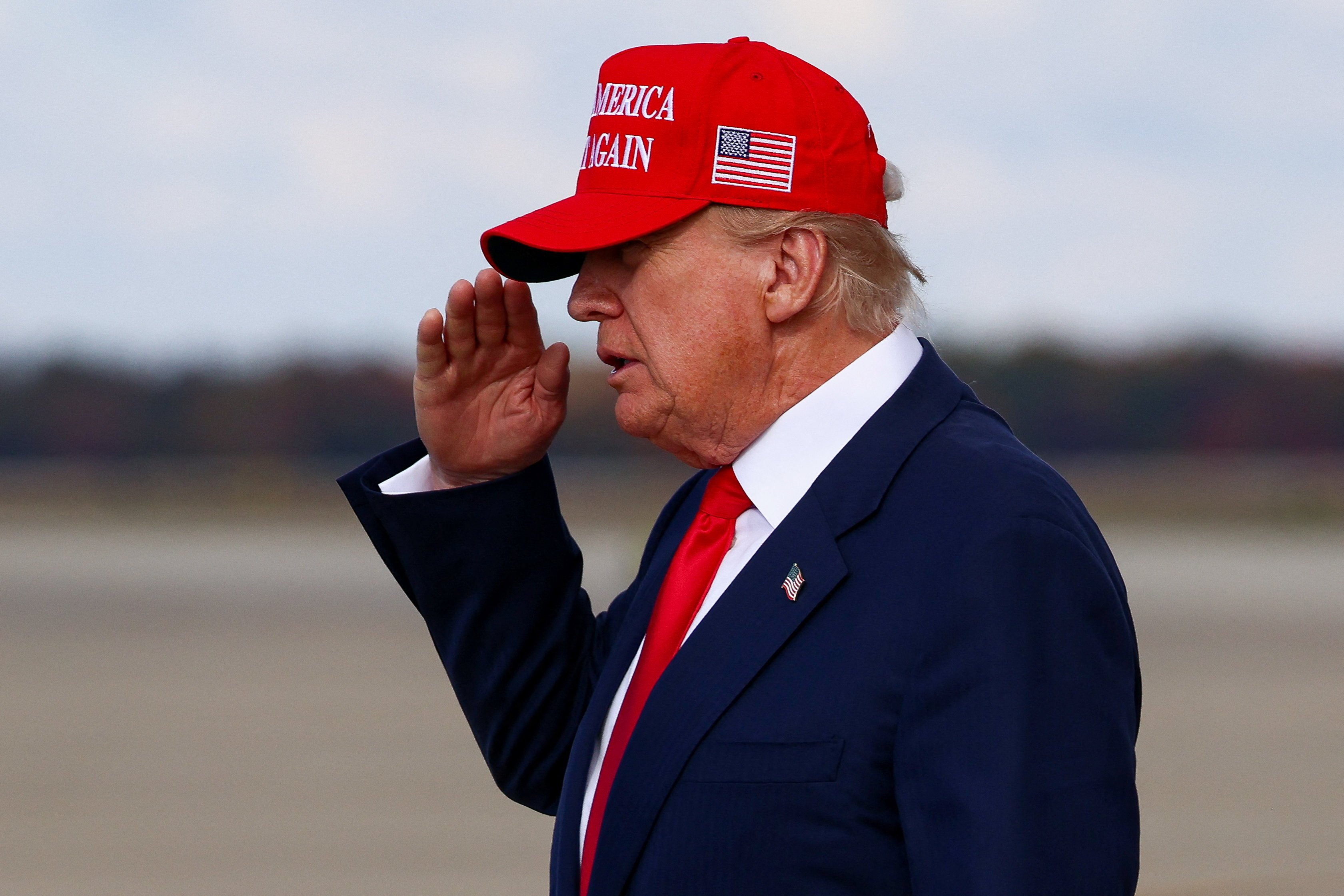 US President Donald Trump salutes after disembarking Air Force One. Photo: Reuters