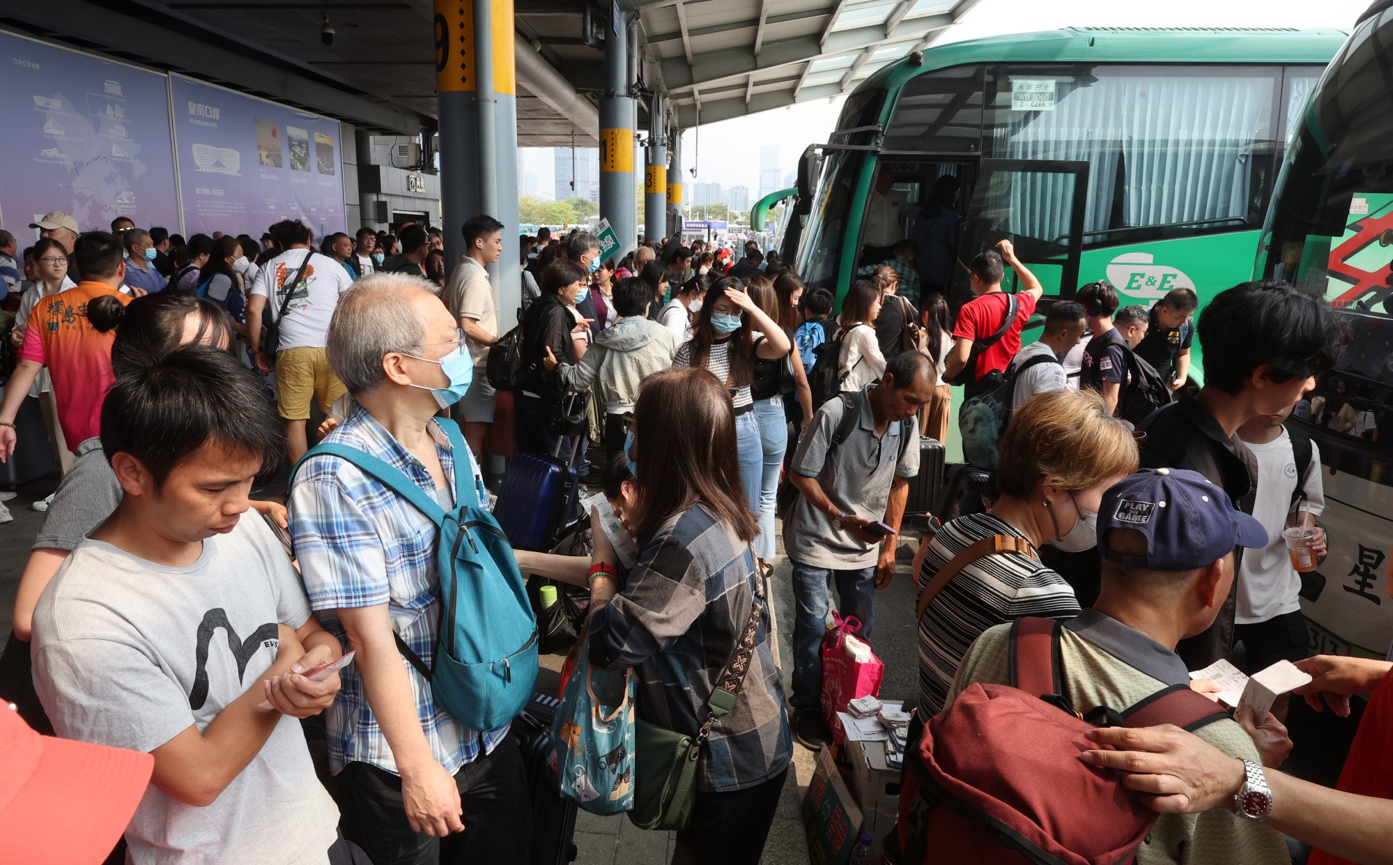 Travellers wait for cross-boundary coaches at the border. Photo: Edmond So