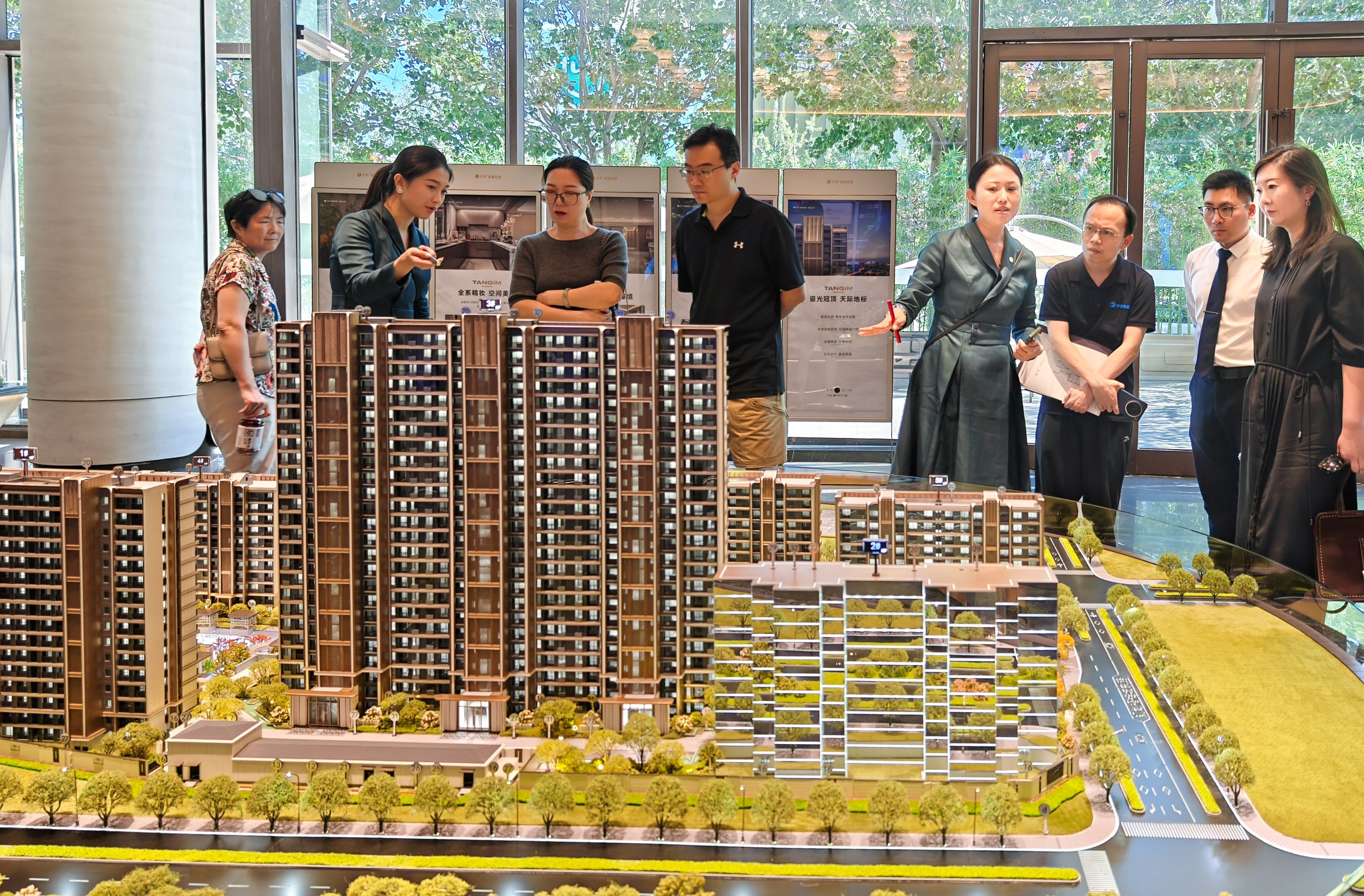 People look at property models at a real estate sales office outside Beijing’s fifth ring road on August 9, after the authorities announced that some purchase restrictions were being removed. Photo: China News Service via Getty Images