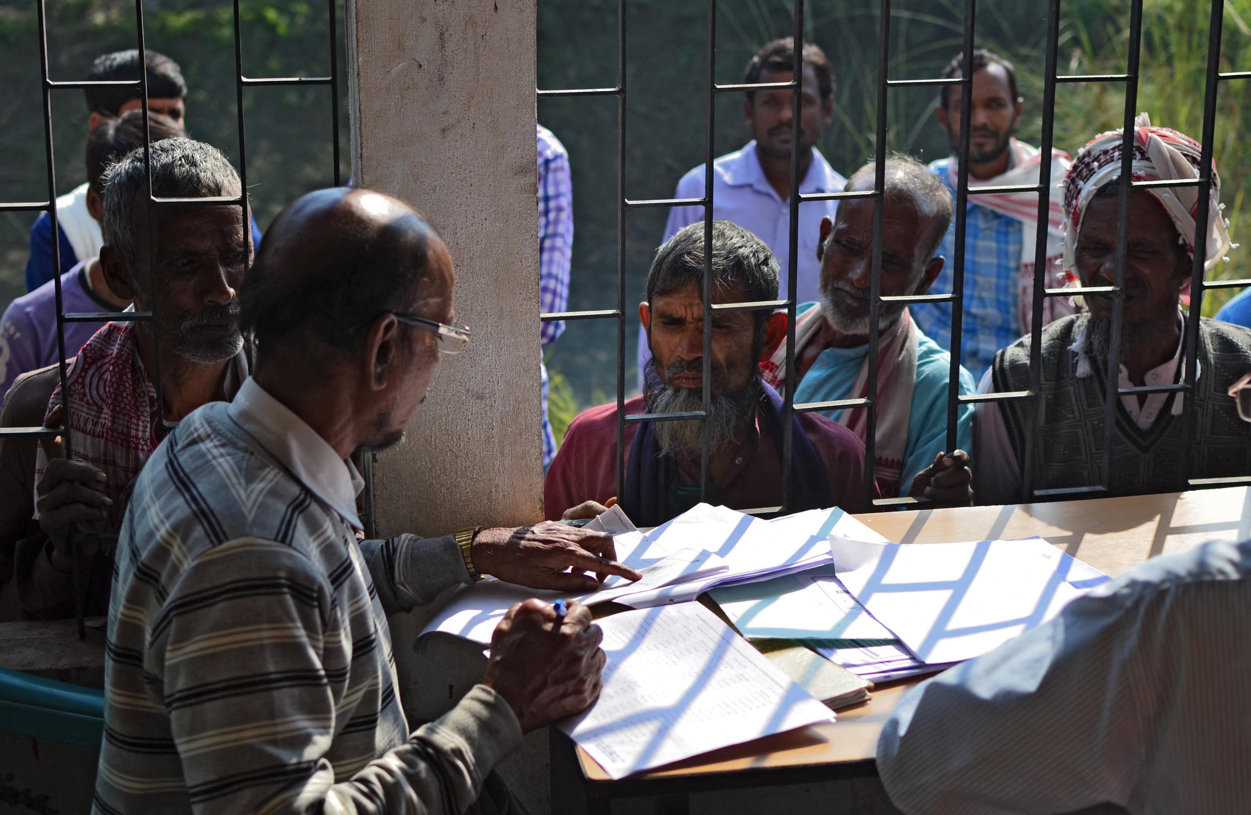 People check their names on the first draft of India’s National Register of Citizens in Assam in 2018. On Thursday, India began revising its voter rolls, raising concerns about potential disenfranchisement in the world’s largest democracy. Photo: AFP