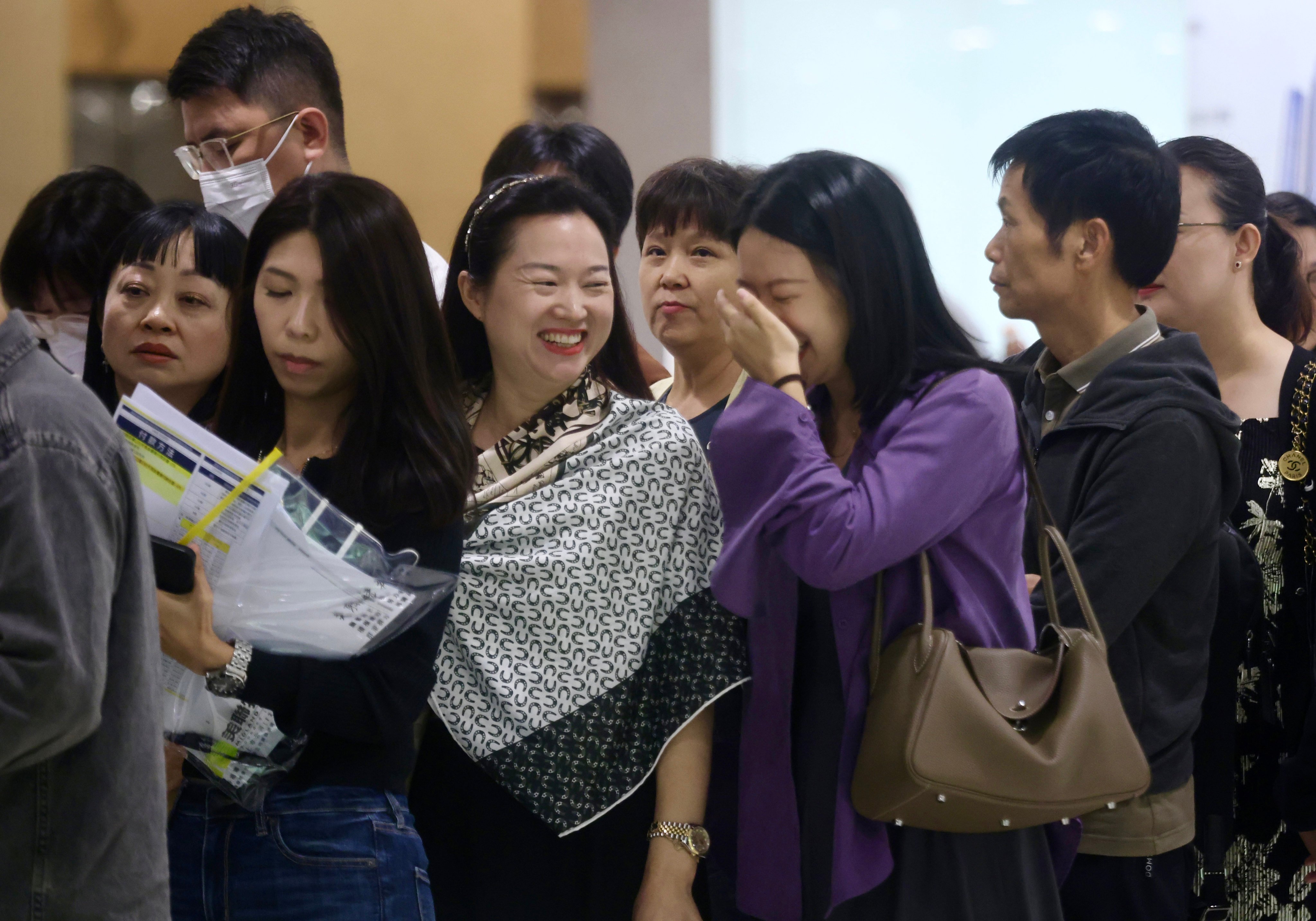 Homebuyers on Sunday stand in line at the sales office of Wheelock Properties’ Spring Garden residential project in Wan Chai. Photo: Jonathan Wong