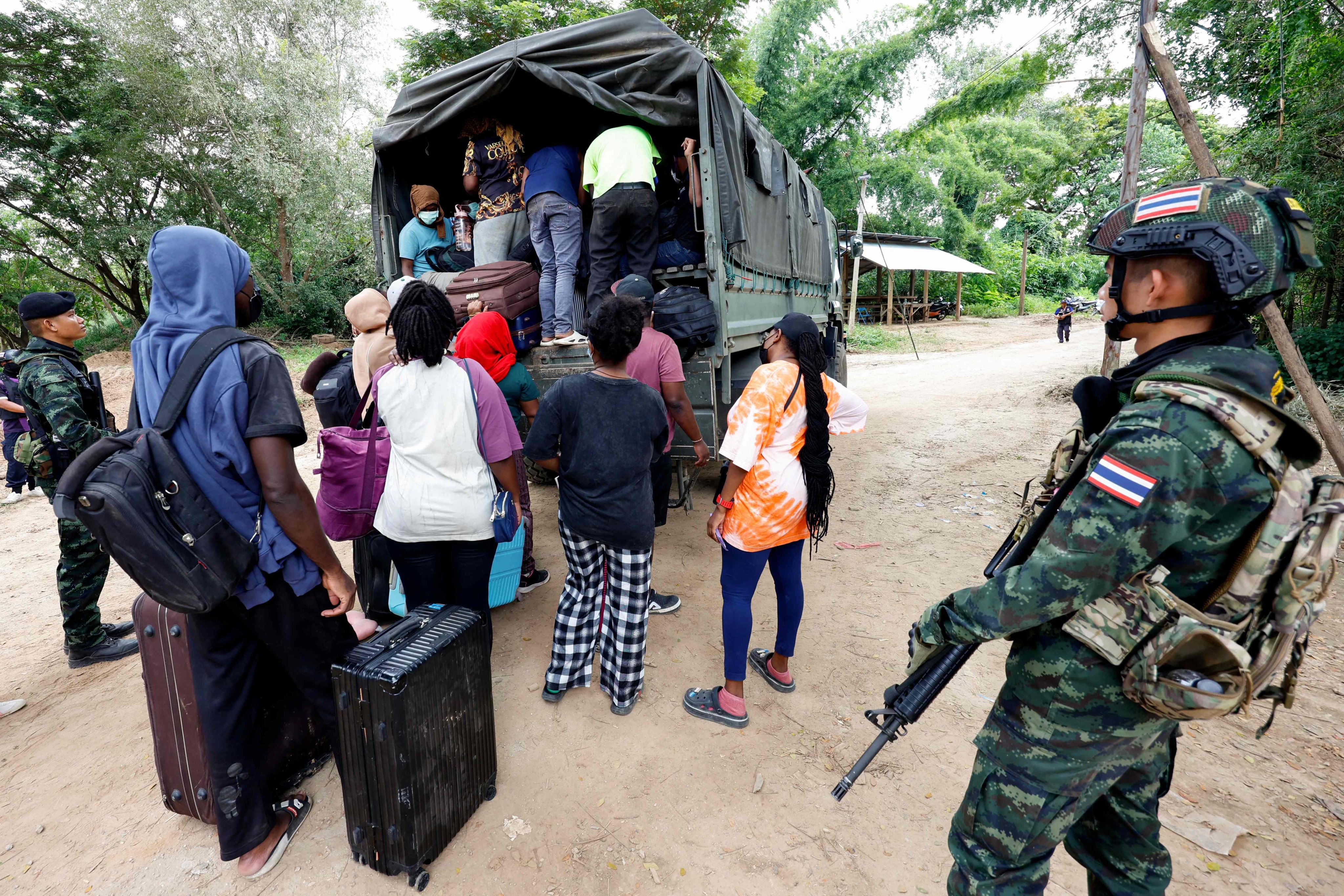 People, who were working in the KK Park scam compound in Myanmar and crossed to Thailand, board a vehicle in Mae Sot district, Tak province, on October 24. Photo: Thai News Pix/AFP