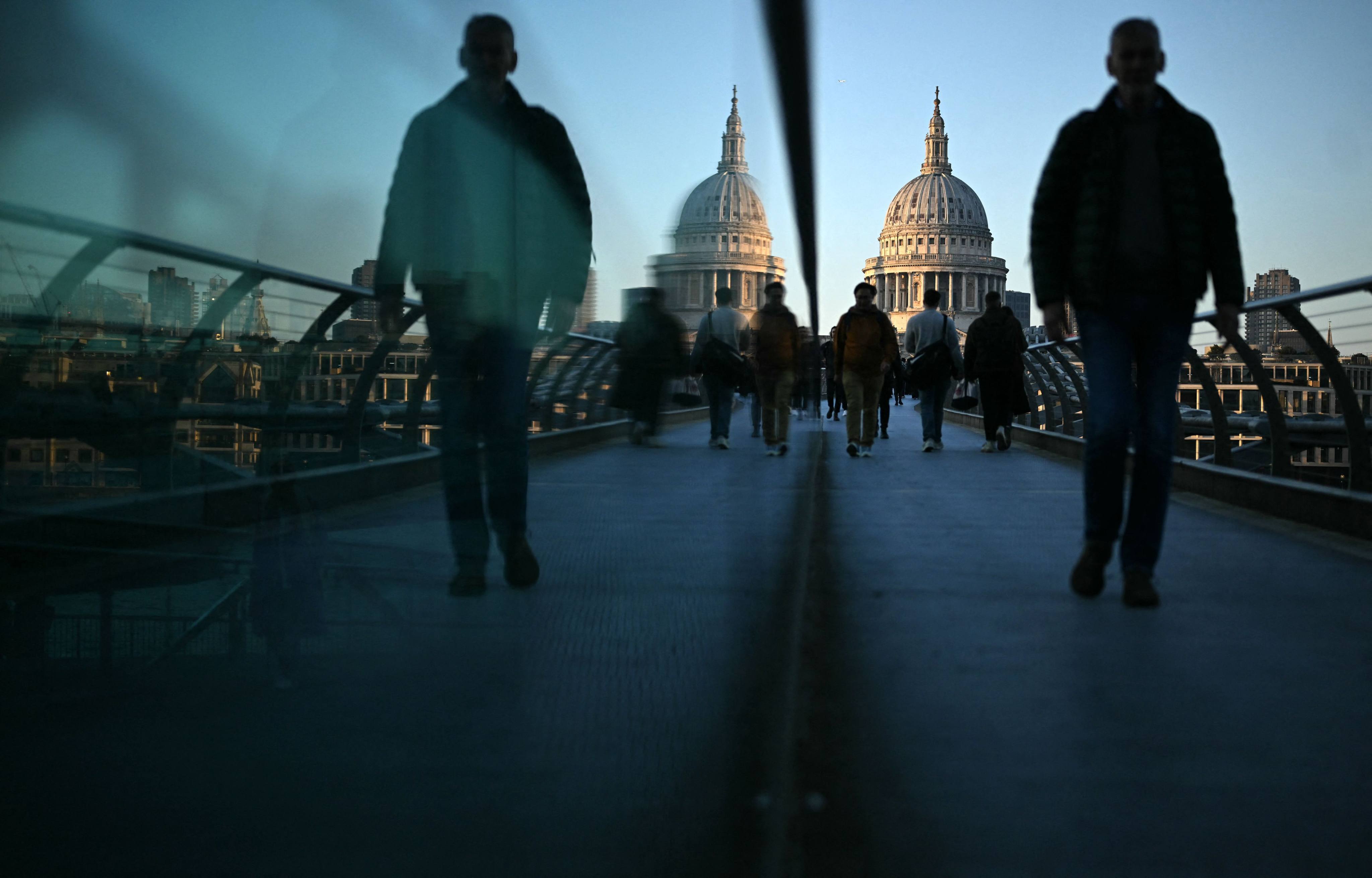 Commuters on the Millennium Bridge in London in March 2025. Researchers are finding that city strolls can be just as good for your mental health as walks in nature. Photo: AFP