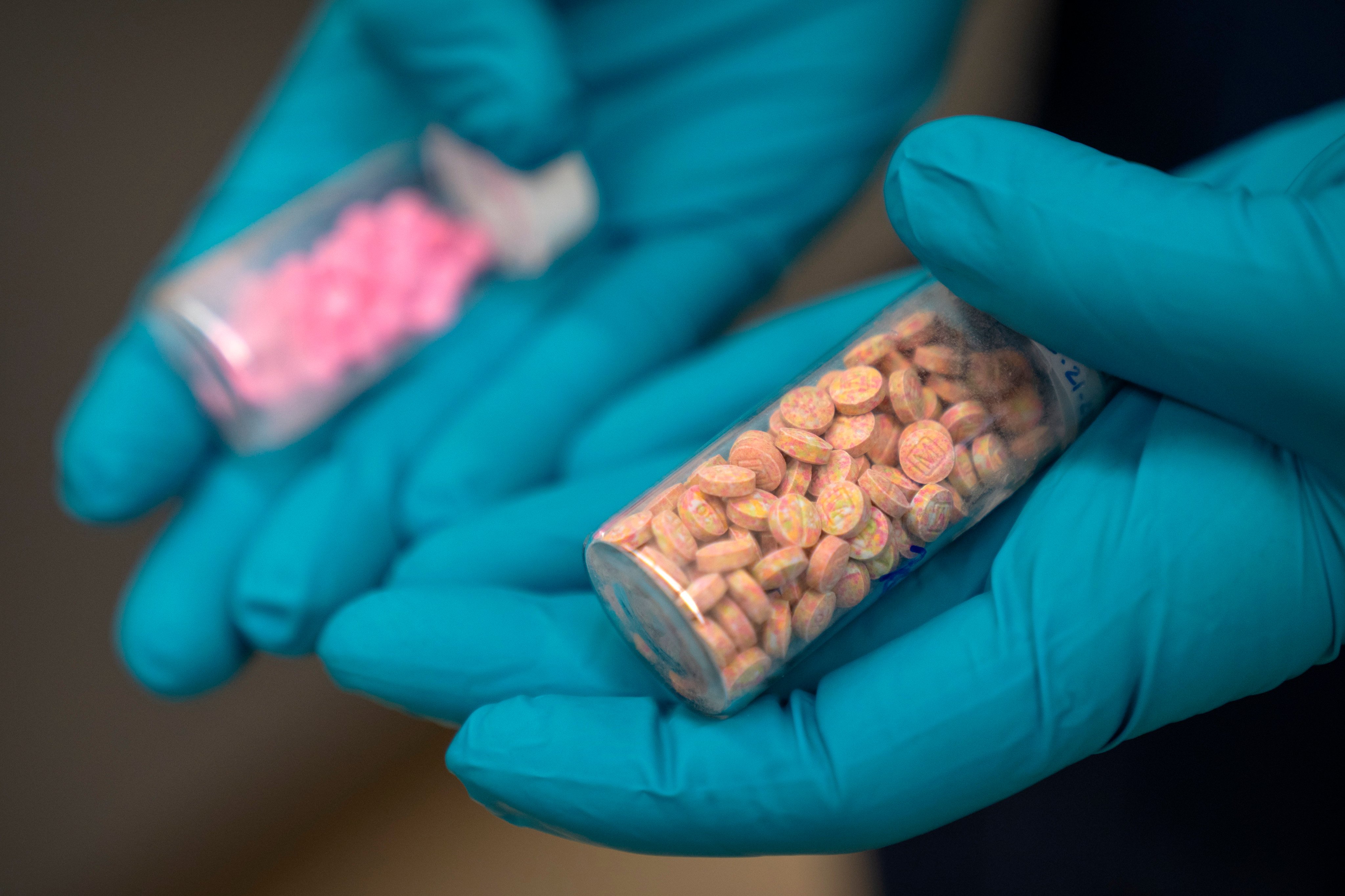 A chemist holds vials of fentanyl pills at a DEA research laboratory in Virginia in April. Photo: AP