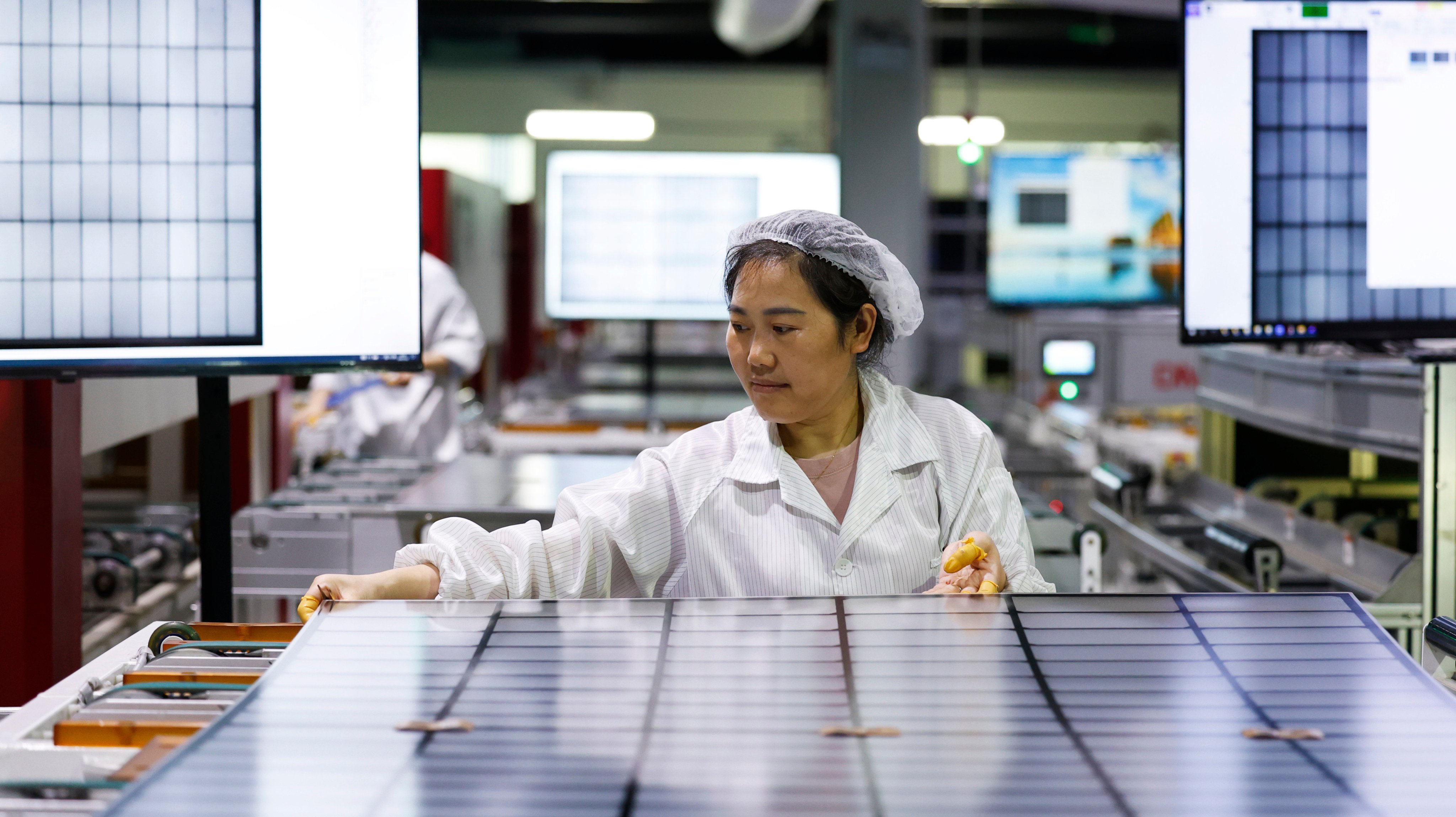 A worker makes a photovoltaic module at a factory in Suqian, Jiangsu province, on July 22. Photo: CFOTO / Future Publishing via Getty Images