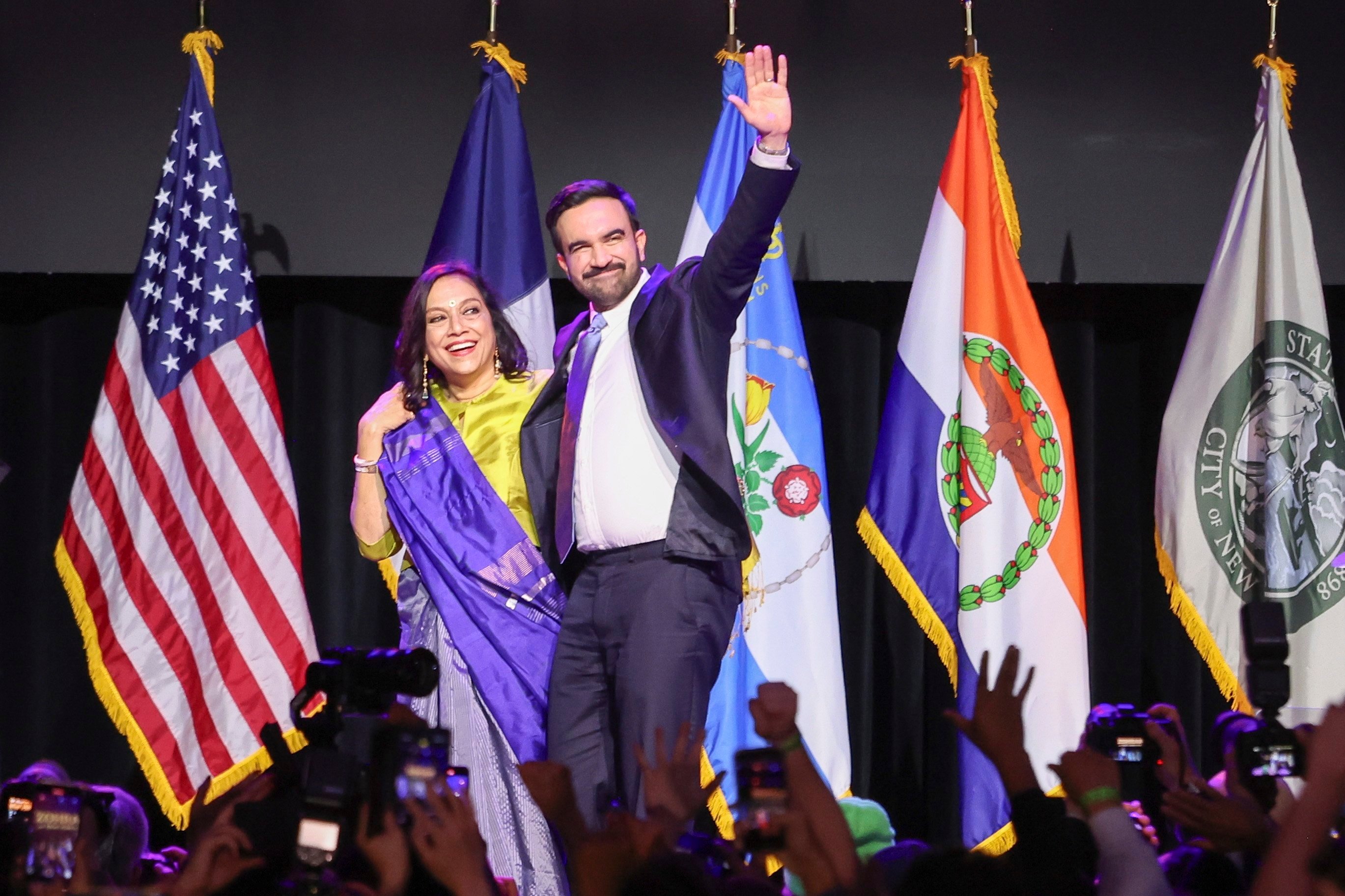 New York Mayor-elect Zohran Mamdani and his mother Mira Nair wave to the crowd during an election night party in Brooklyn on Tuesday. Photo: EPA