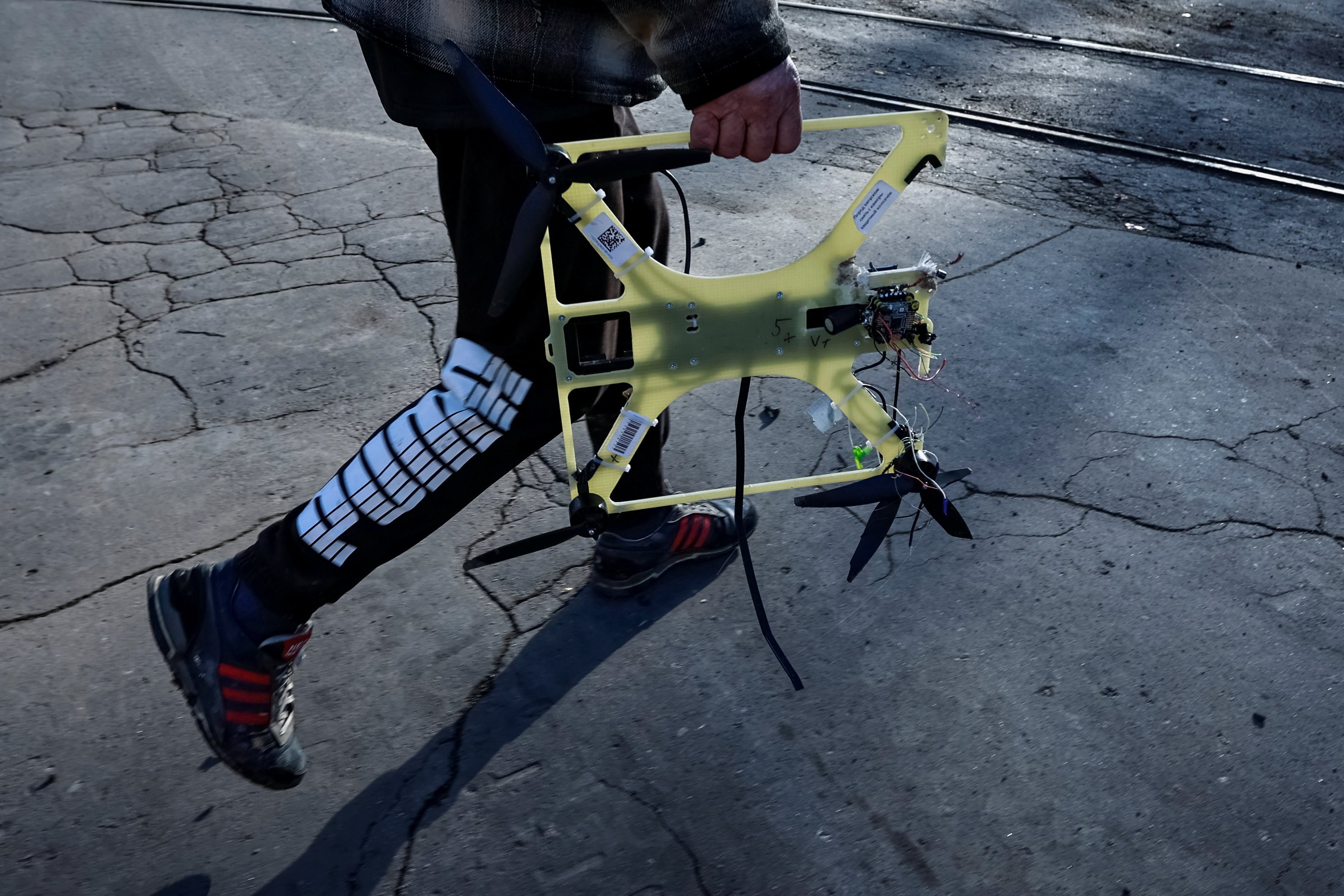 A resident carries a downed Russian FPV drone in the frontline town of Kostiantynivka in Donetsk region, Ukraine earlier this month. Photo: Reuters