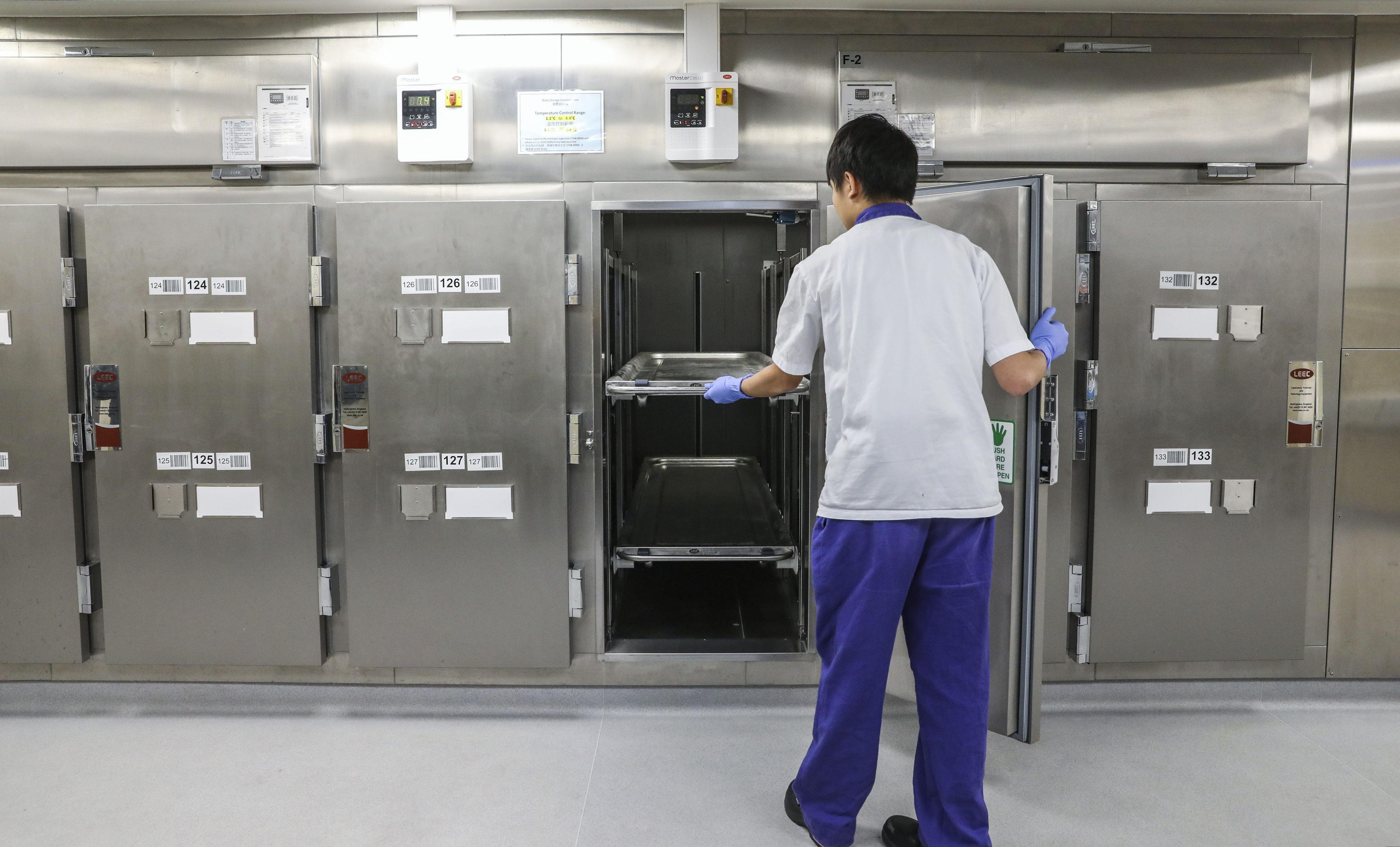 A worker at the mortuary in Queen Mary Hospital in Pok Fu Lam. Photo: K. Y. Cheng