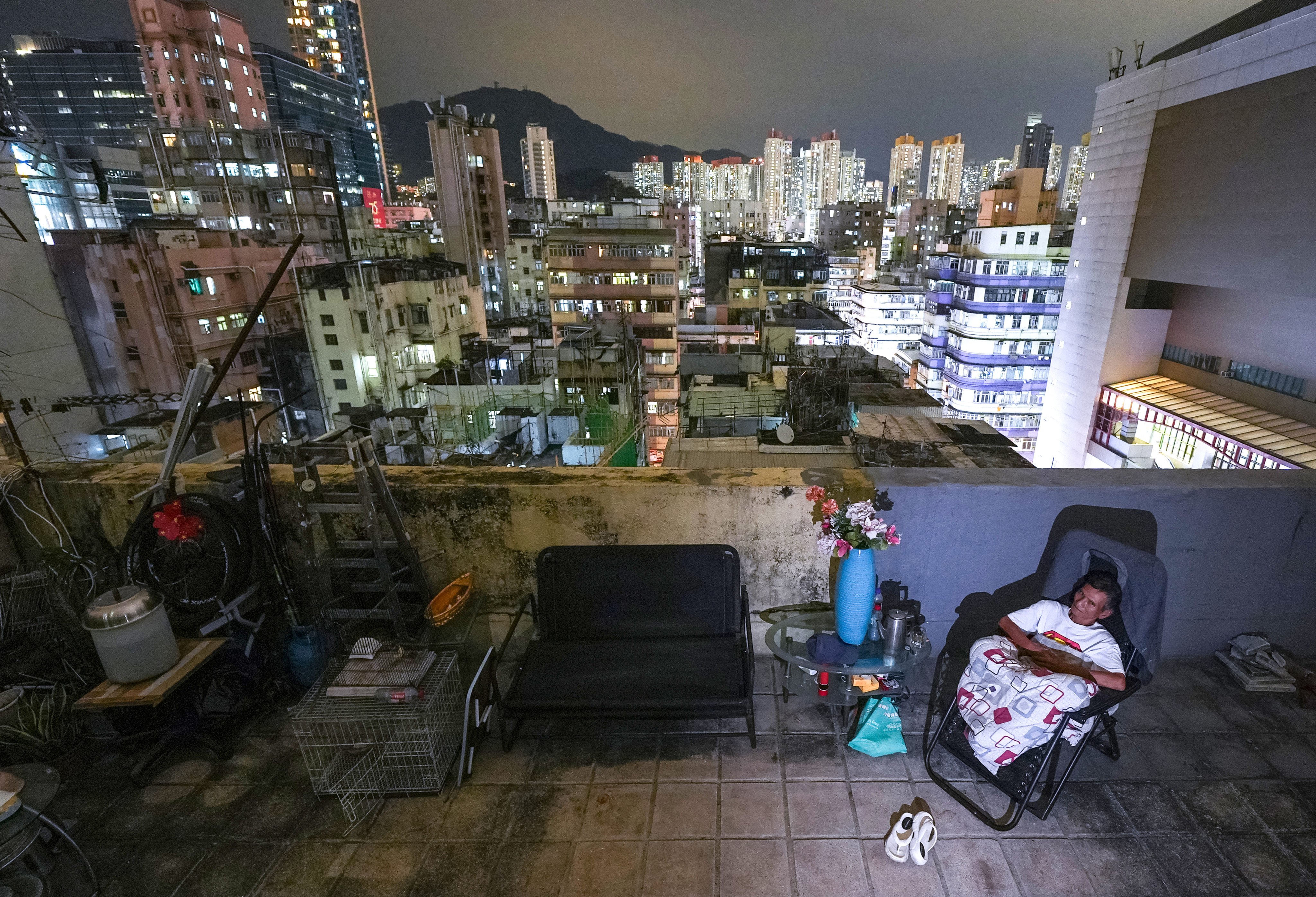 Chan relaxes outside his rooftop home in Sham Shui Po, in a photo that is part of an award-winning series. Photo: Eugene Lee