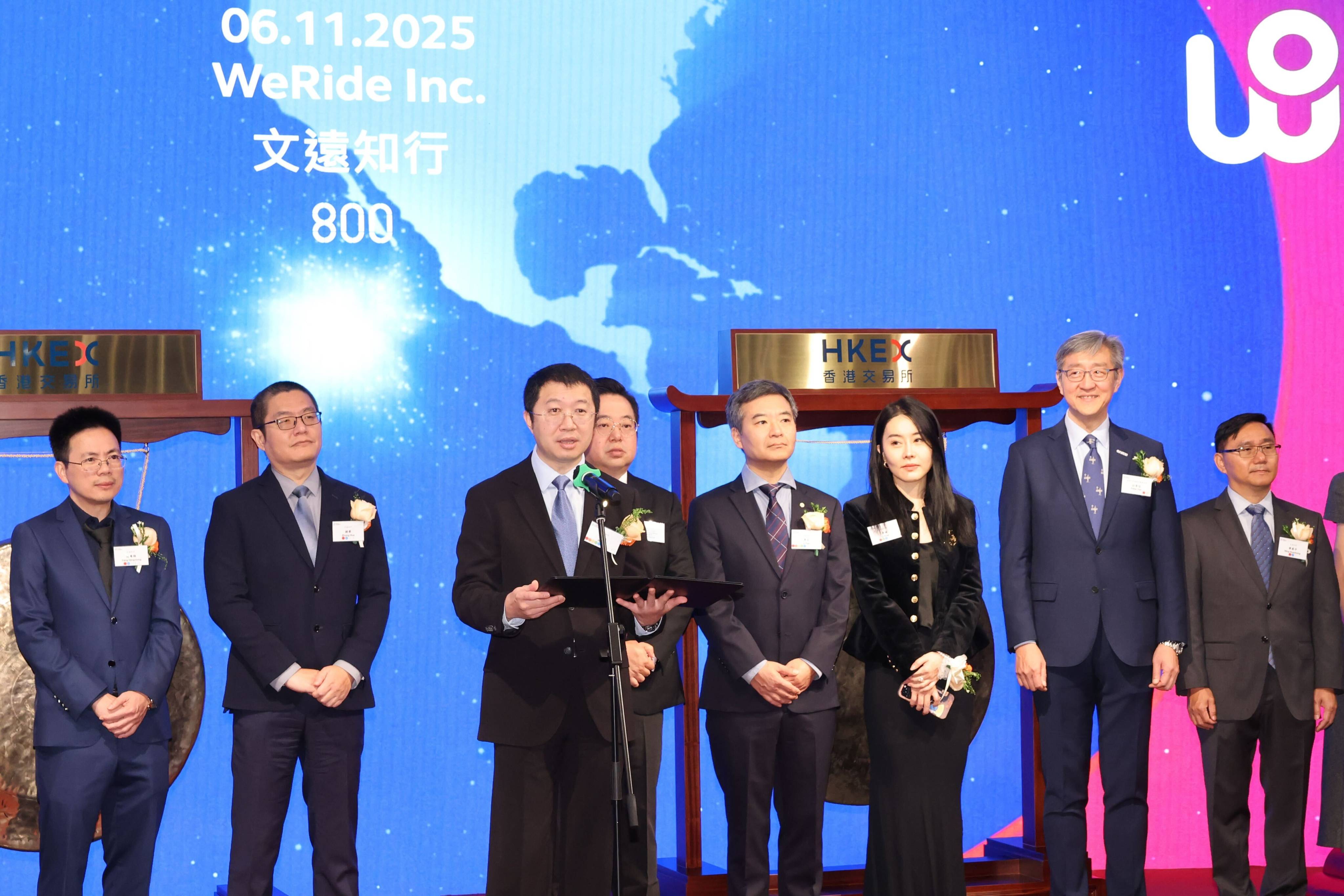 Tony Han, founder and CEO of WeRide (at microphone), speaks at the company’s listing ceremony at the headquarters of bourse operator Hong Kong Exchanges and Clearing in Central on November 6, 2025. Photo: Nora Tam