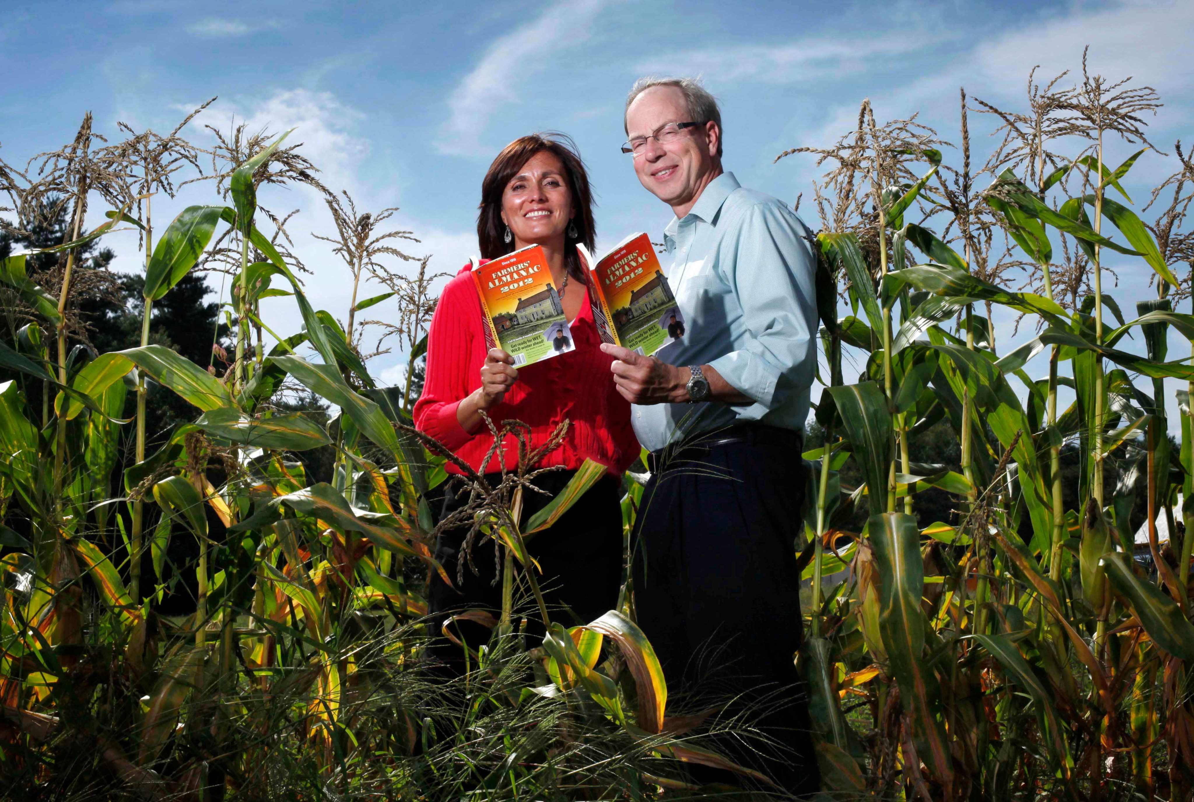 Farmers’ Almanac editor Sandi Duncan and publisher Peter Geiger pose in a corn field with the 2012 edition of the almanac. Photo: AP