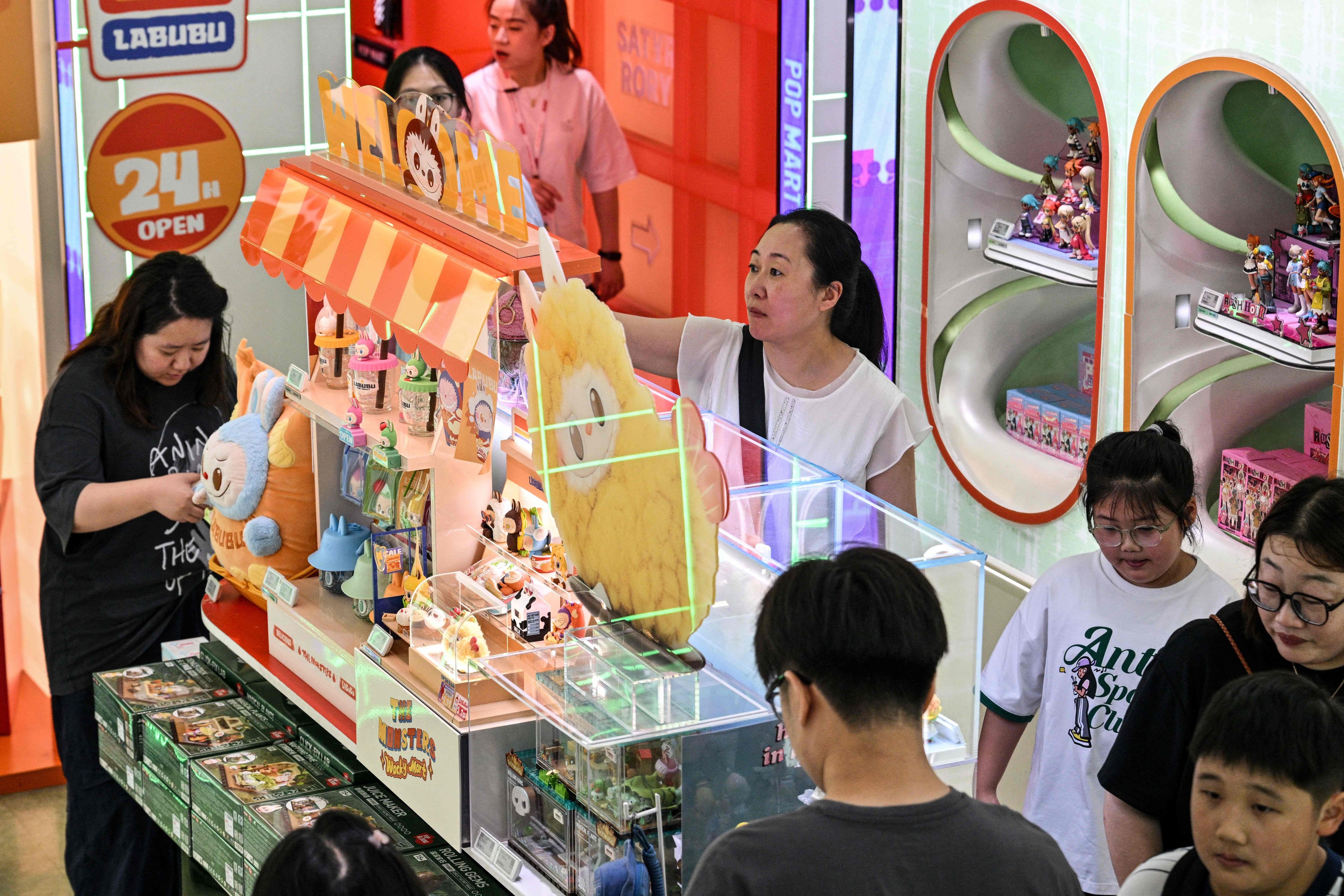 Customers look at Labubu merchandise at a Pop Mart shop in Shanghai on August 29, 2025. Photo: AFP