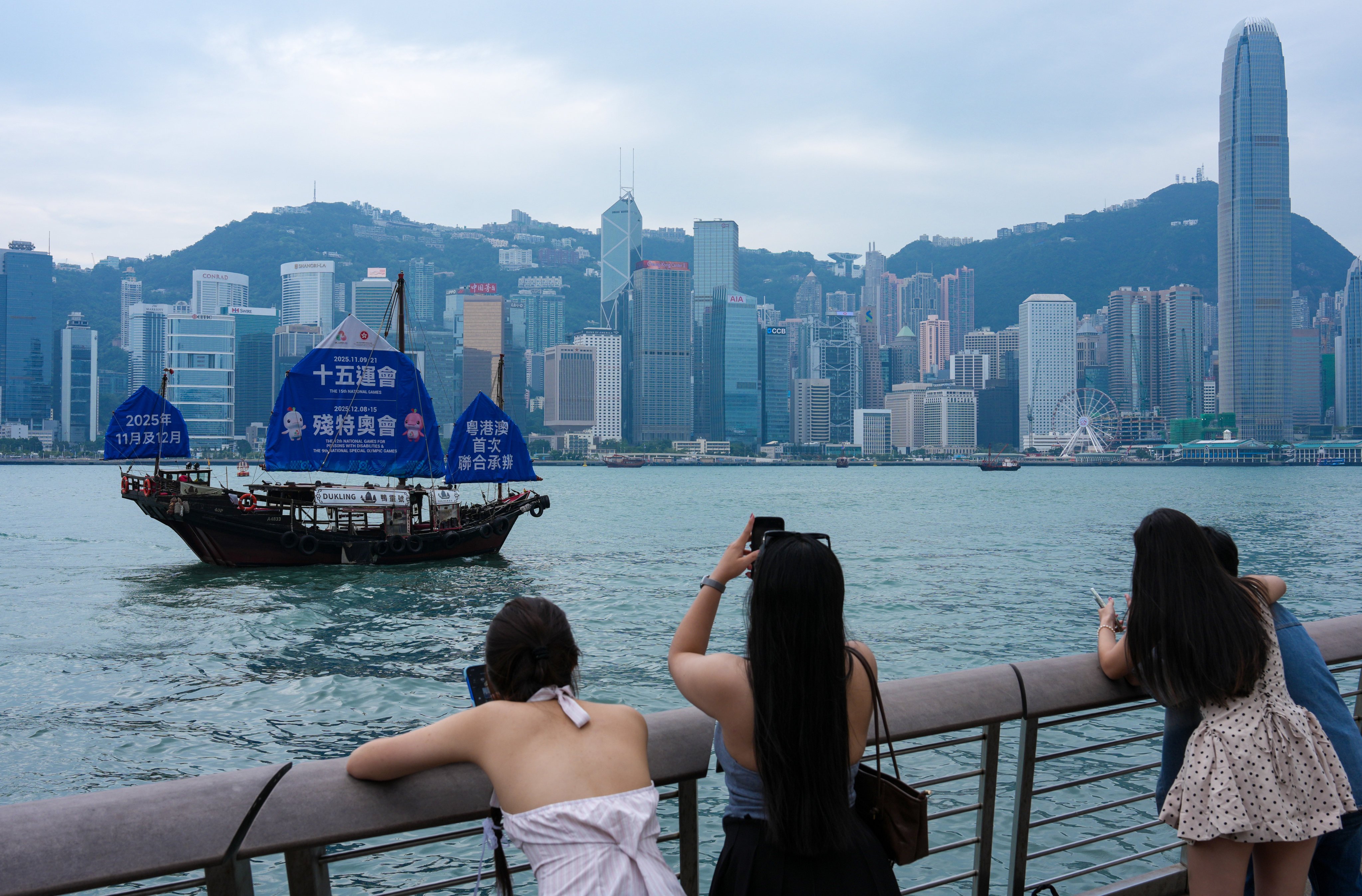 A Chinese sailboat with a giant poster for the 15th National Games and the Special Olympics sails through Victoria Harbour in Tsim Sha Tsui. Photo: Jelly Tse
