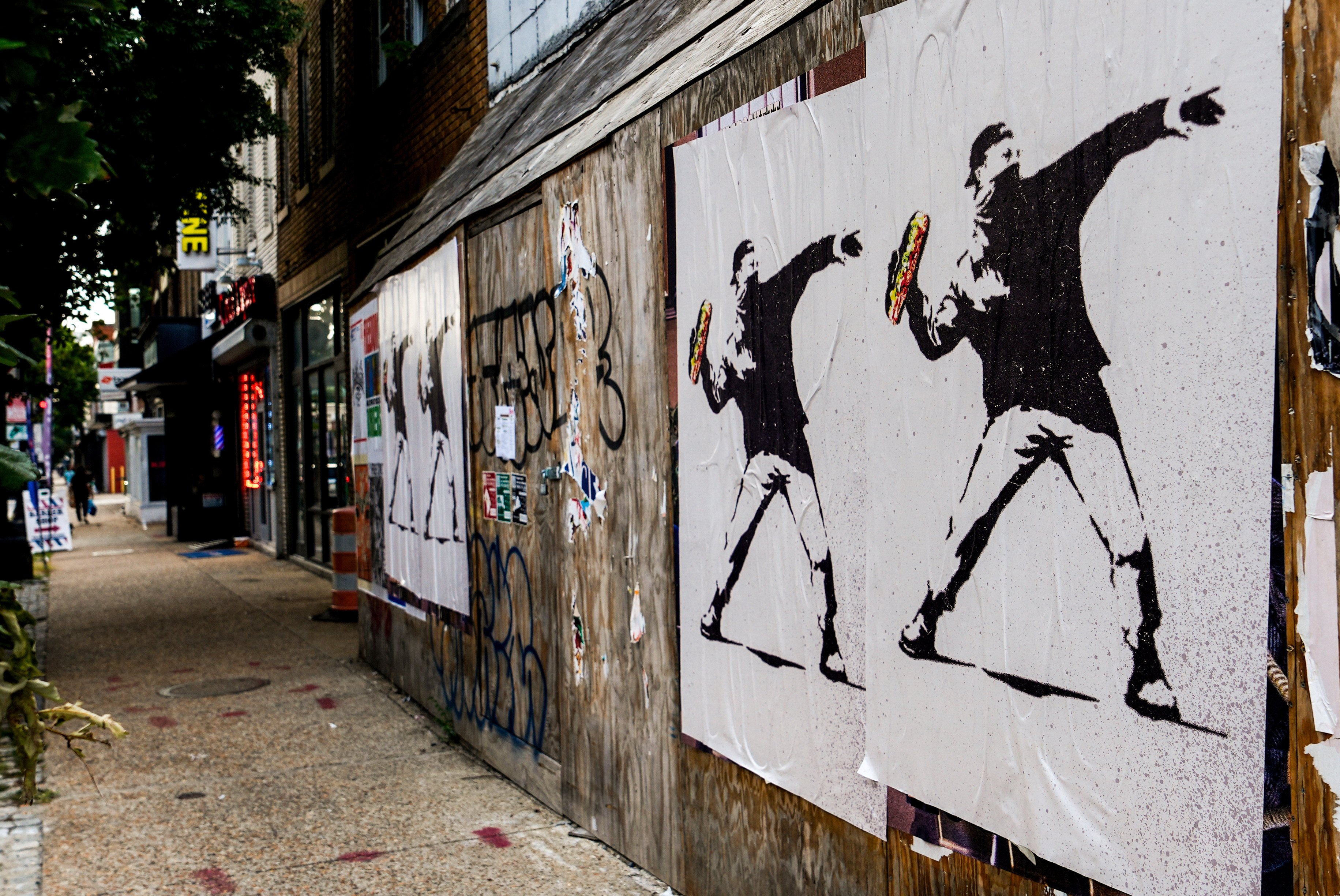 Posters of a man throwing a sandwich are pictured in Washington in August. Photo: AP