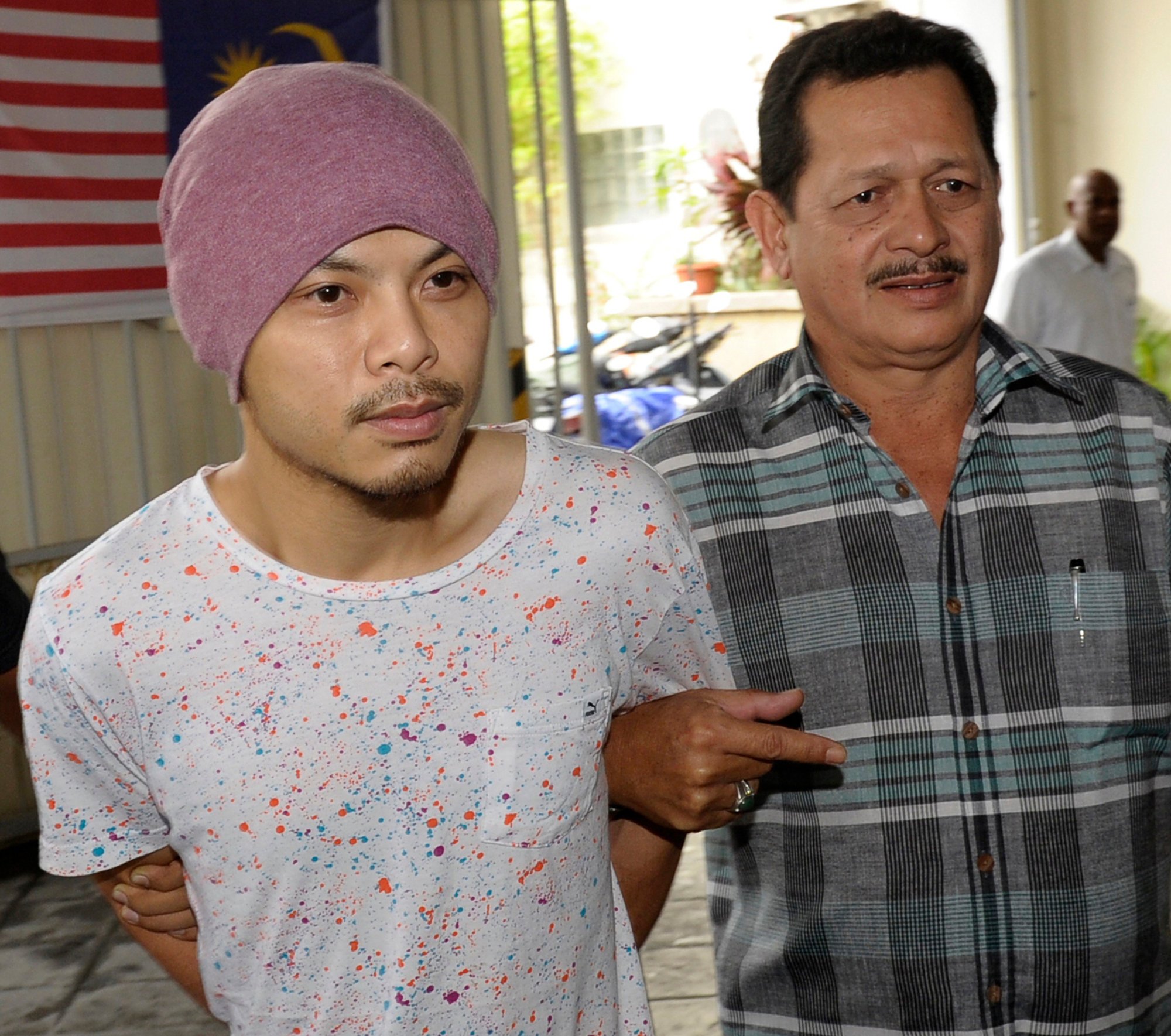 Malaysian rapper Namewee is escorted by plainclothes policemen to a Penang magistrate’s court hearing in 2016. Photo: AP Malaysian rapper Namewee is escorted by plainclothes policemen to a Penang magistrate’s court hearing in 2016. Photo: AP