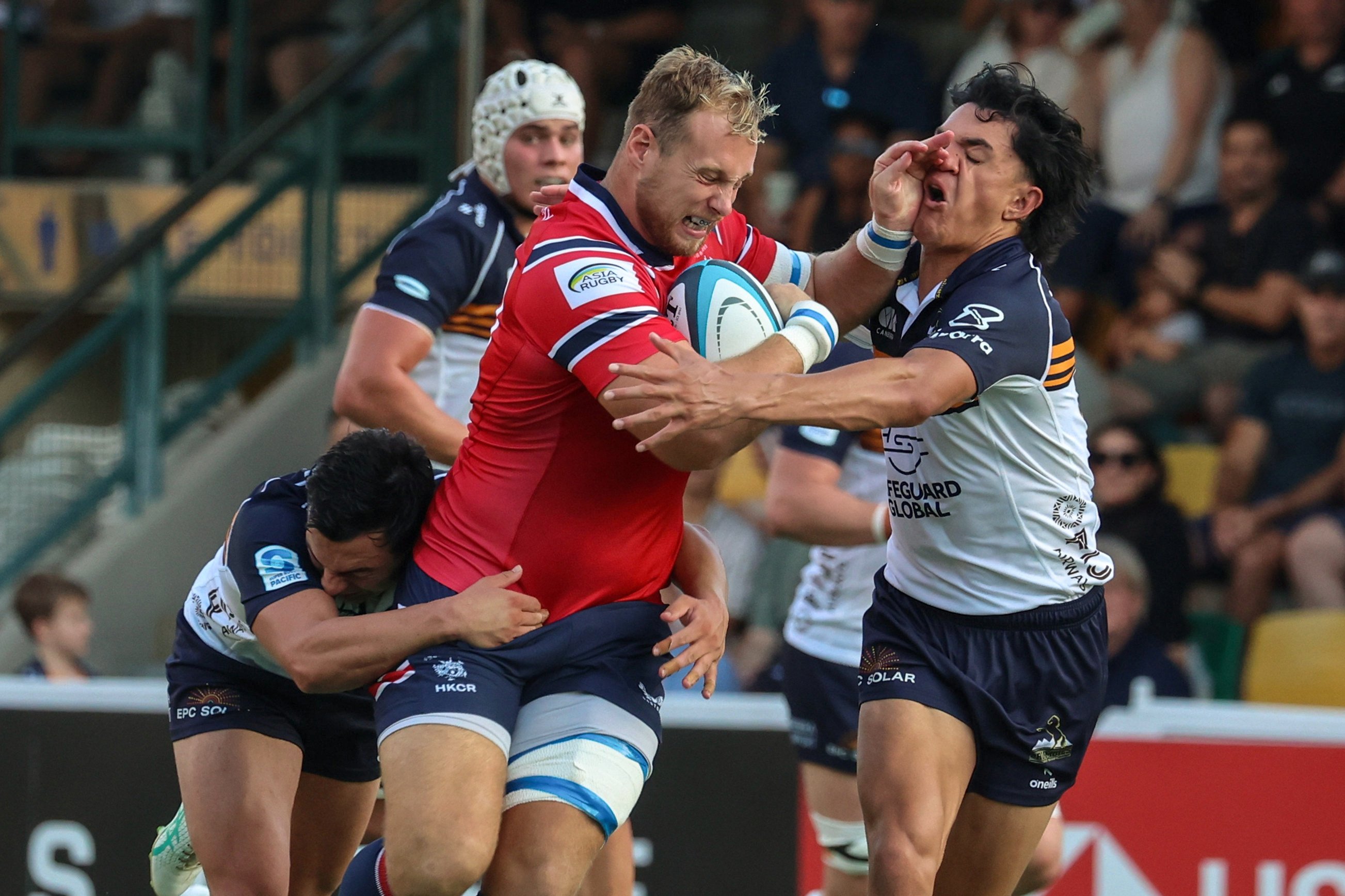 Hong Kong No 8 Jack Bartlett takes on the ACT Brumbies defence in their match at Football Club on Saturday. Photo: Edmond So