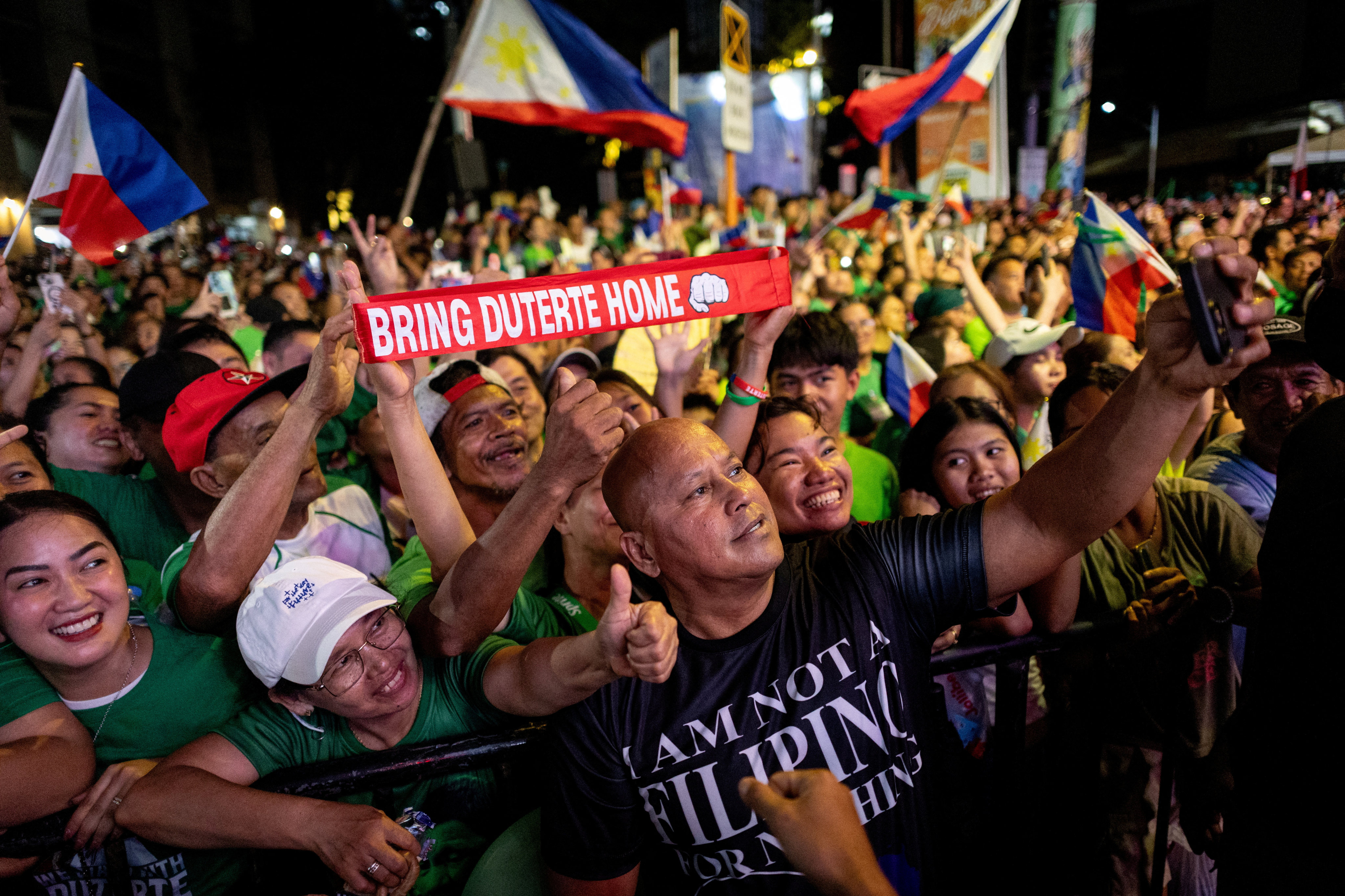 Philippine Senator Ronald Dela Rosa takes a selfie with Rodrigo Duterte’s supporters in Davao City on March 28. Photo: Reuters