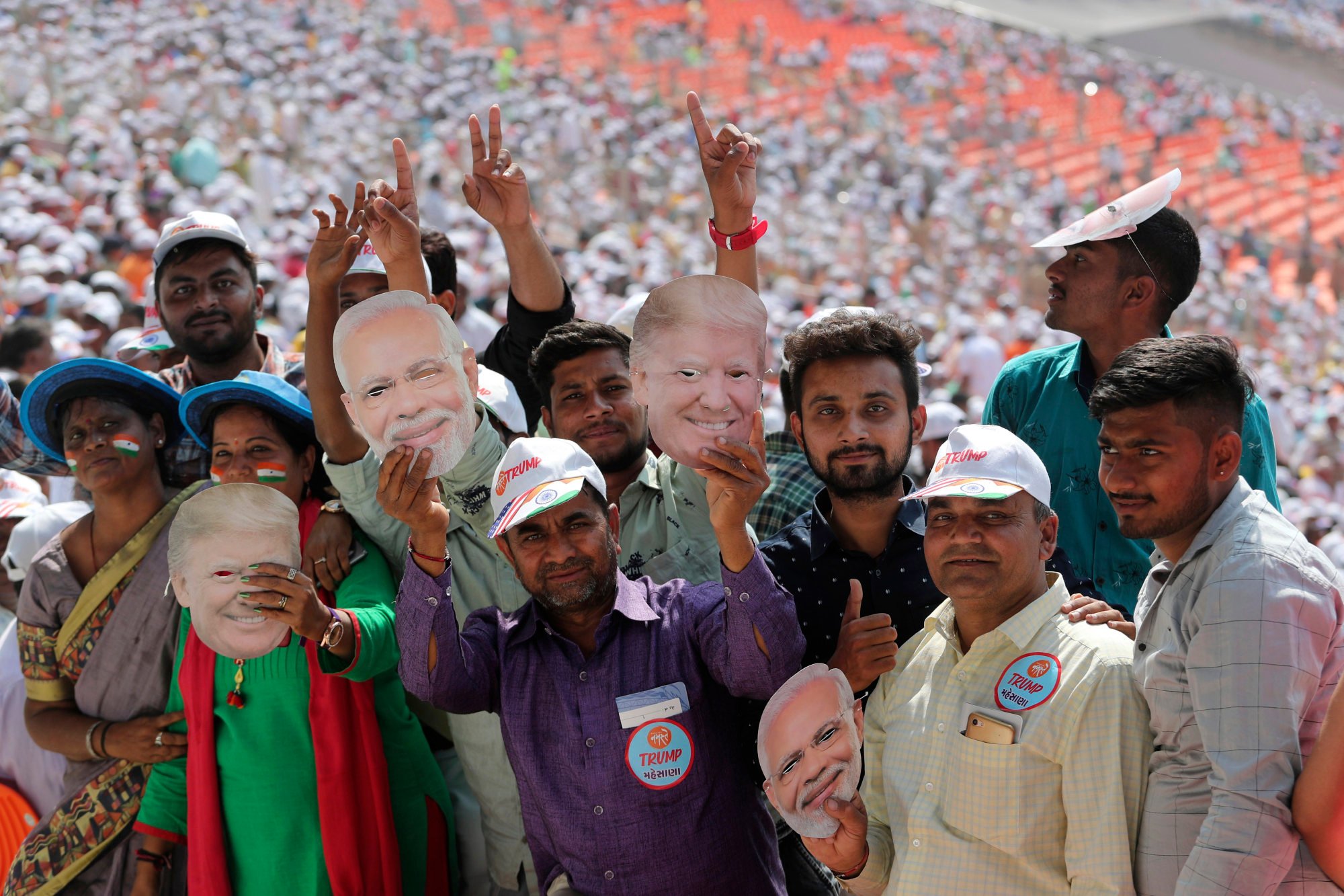 Happier times: Indians hold masks of US President Donald Trump and Indian Prime Minister Narendra Modi as they wait for a “Namaste Trump” to start in Ahmedabad, India, in February 2020. Photo: AP Happier times: Indians hold masks of US President Donald Trump and Indian Prime Minister Narendra Modi as they wait for a “Namaste Trump” to start in Ahmedabad, India, in February 2020. Photo: AP
