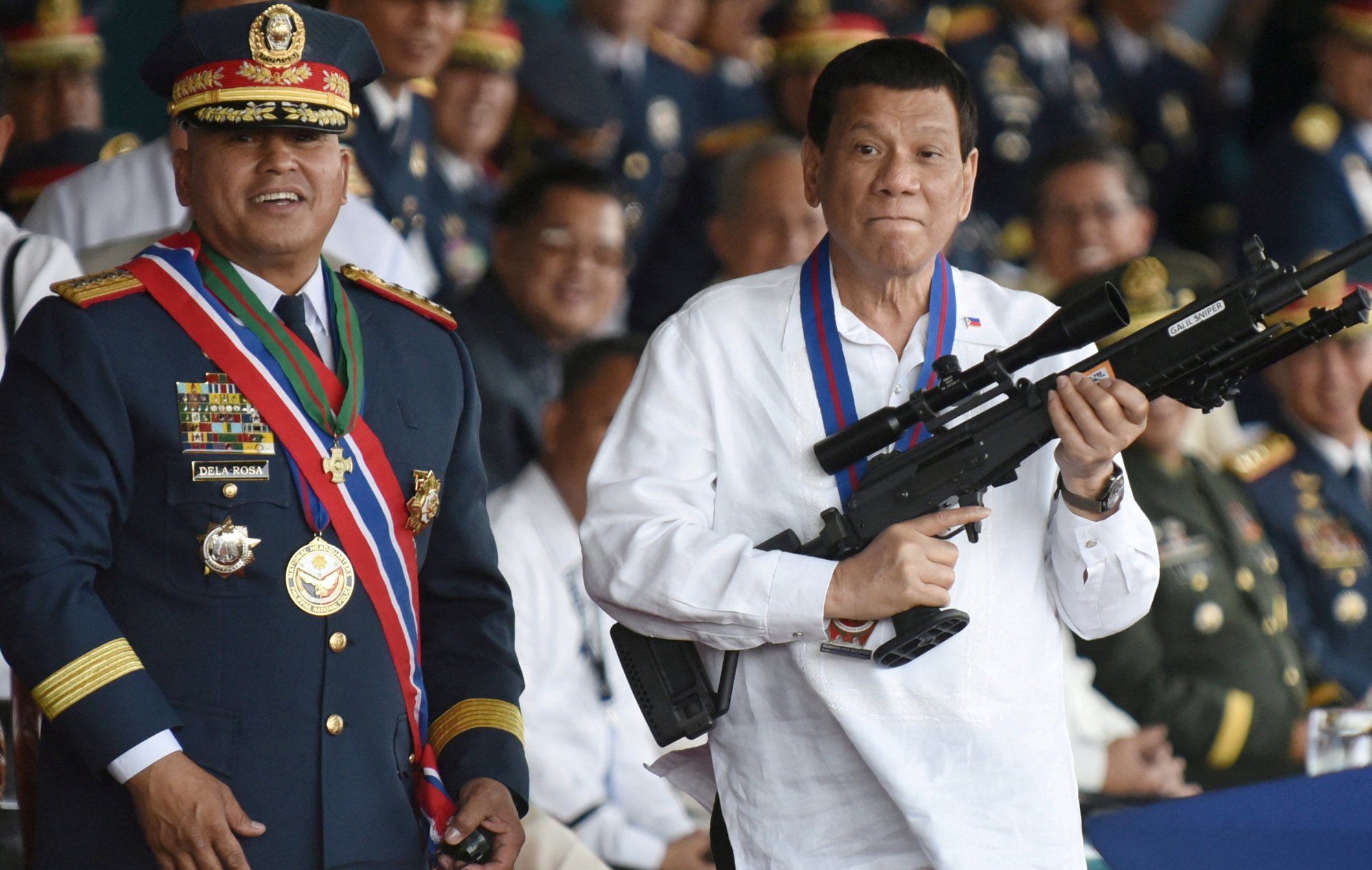 Rodrigo Duterte holds a Galil sniper rifle next to Ronald Dela Rosa during a ceremony in Camp Crame, Quezon City on April 19, 2018. Photo: Reuters Rodrigo Duterte holds a Galil sniper rifle next to Ronald Dela Rosa during a ceremony in Camp Crame, Quezon City on April 19, 2018. Photo: Reuters