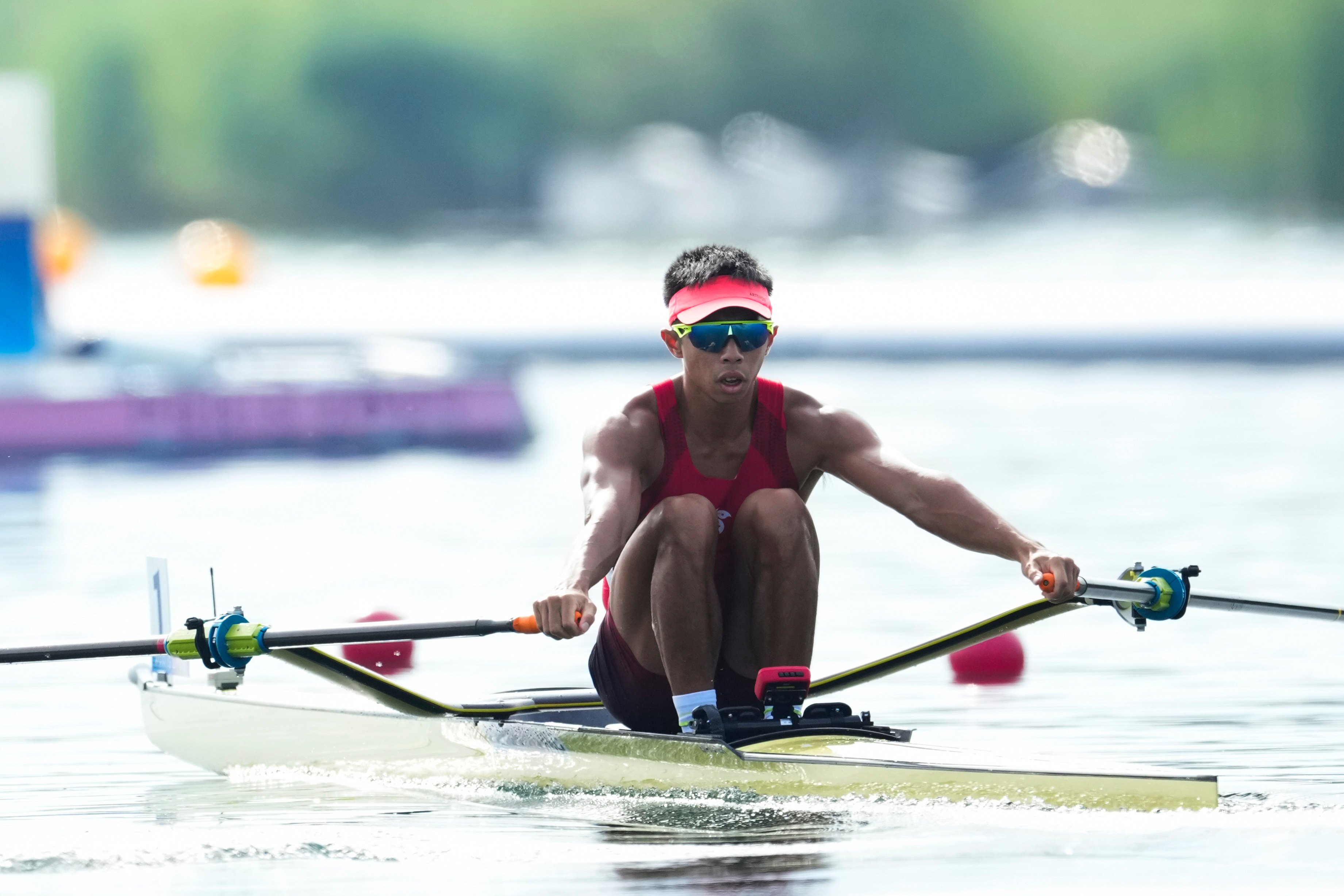 Chiu Hin-chun expects to be more nervous carrying the city’s flag than during his rowing final on Monday. Photo: AP