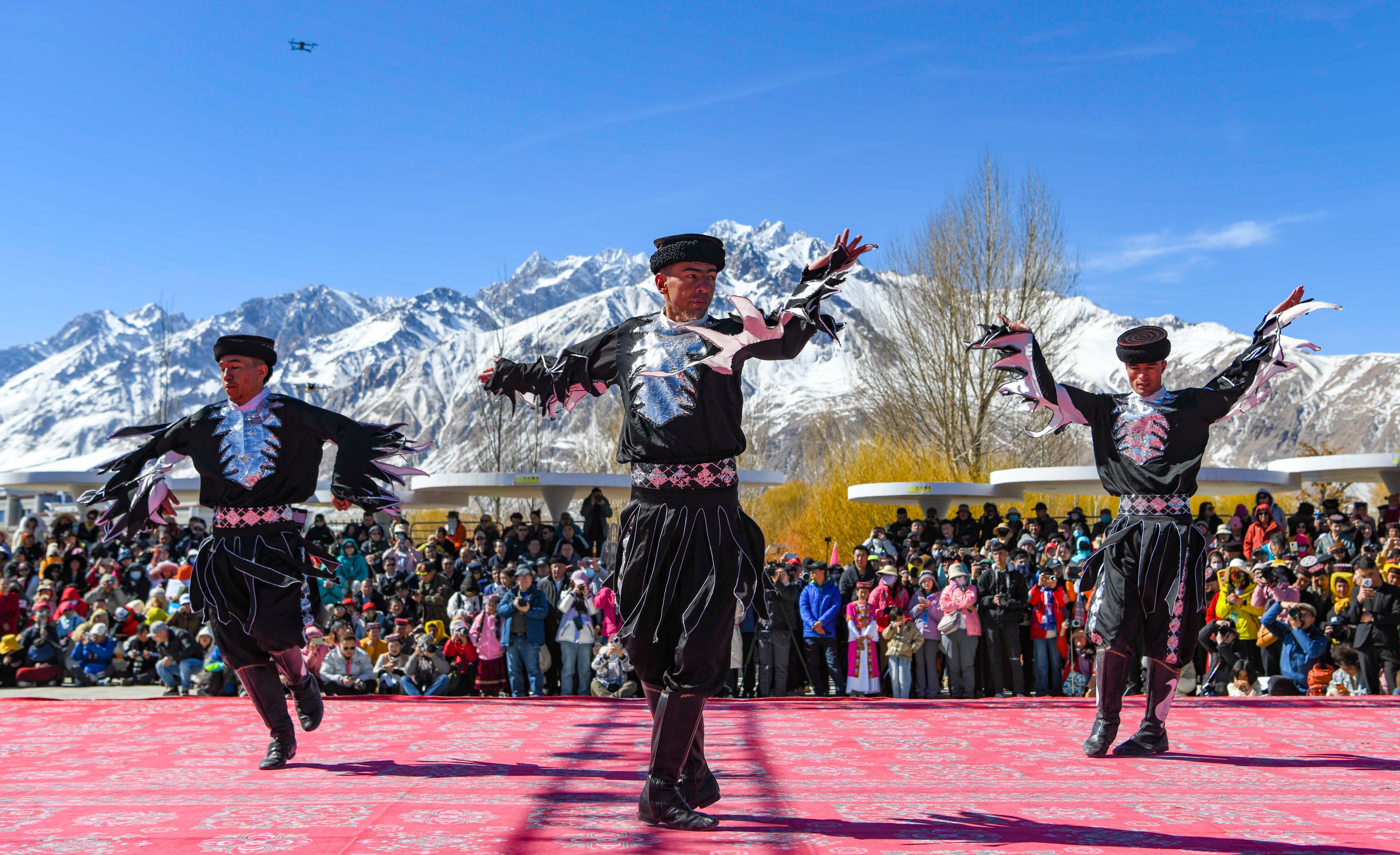 Actors perform an eagle dance in Taxkorgan Tajik autonomous county, Xinjiang Uygur autonomous region, in March while spectators look on. Photo: Xinhua