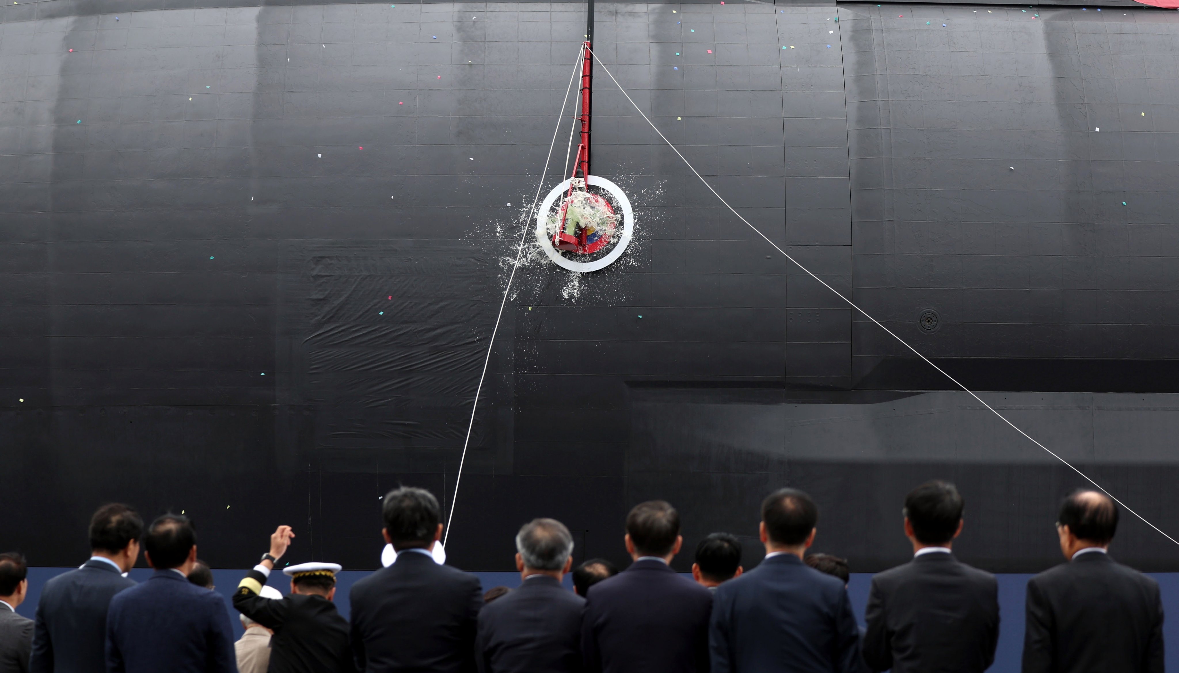 A bottle of champagne is smashed on the hull of South Korea’s first 3,600-ton-class naval submarine during a ceremony held at the Hanwha Ocean dockyard, in Geoje, South Korea, October 22. Photo: Photo: EPA/Yonhap